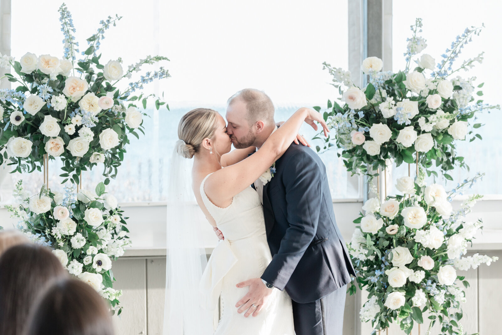 Newlyweds share their first kiss during their Cape Cod wedding.