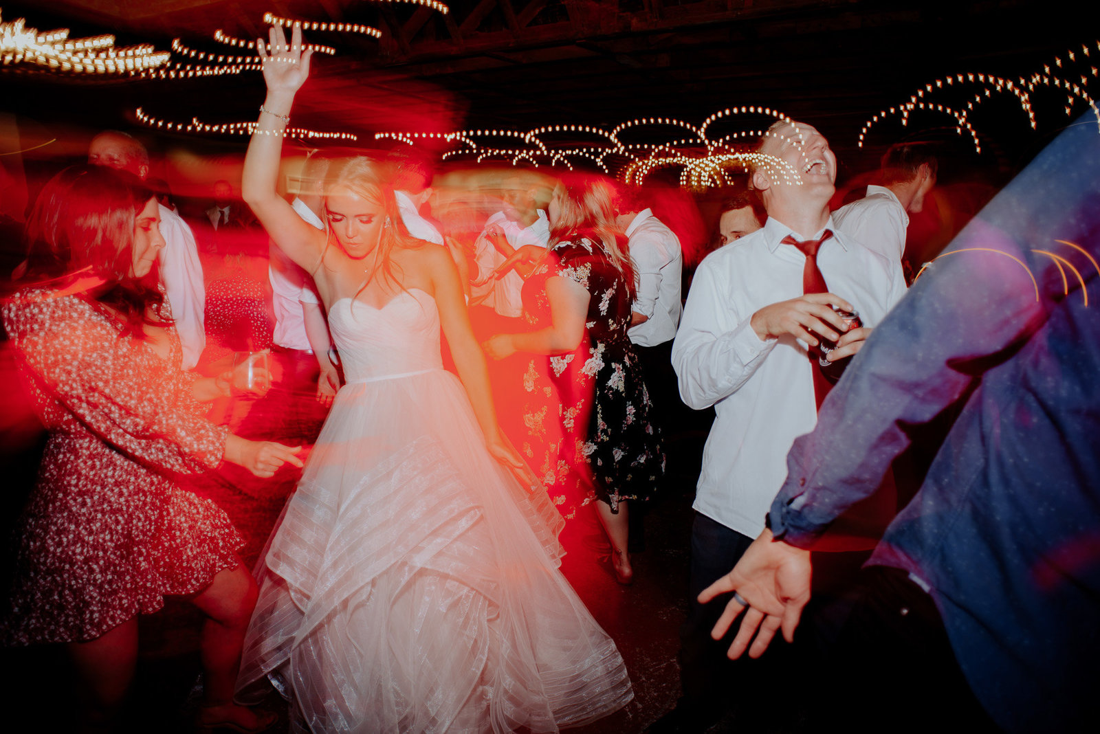 artistic photo of bride dancing into the night