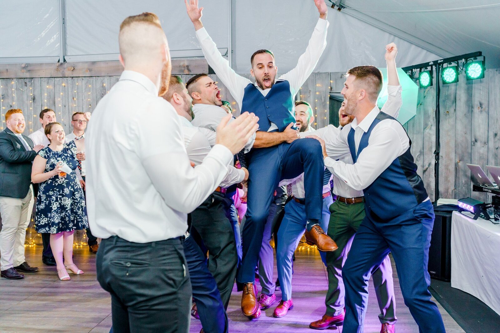 Groomsmen dancing at NH wedding reception with arms in the air