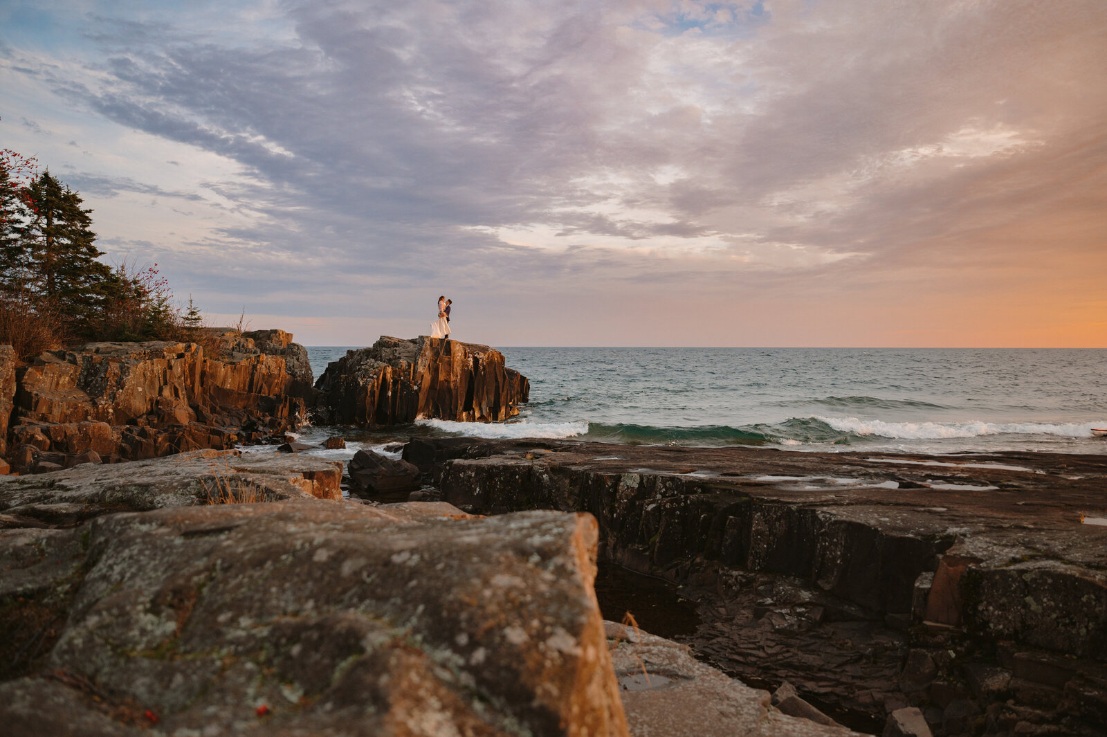 Wedding Couples stand on the cliff by Lake Superior