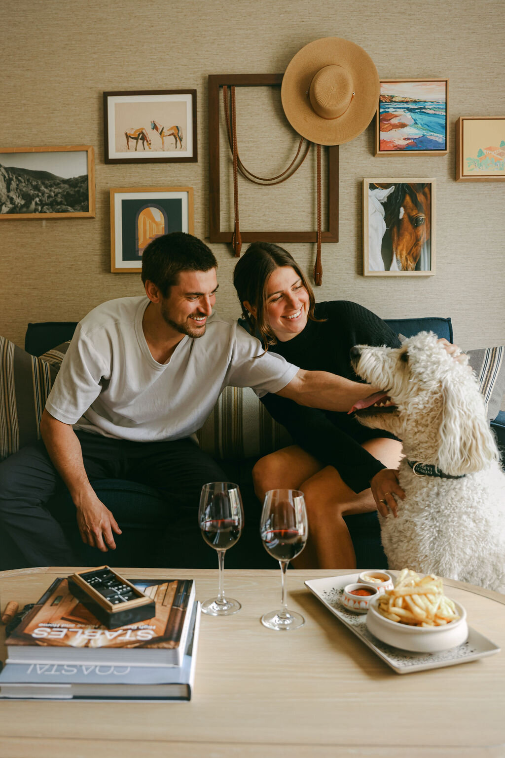 Hotel experience. photographer for luxury and boutique hotels. Couple lounging with dog and wine. Cool hipster.