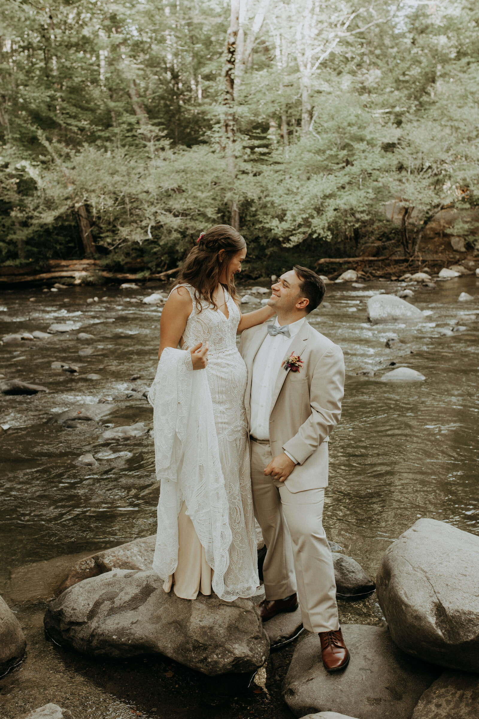 bride and groom by river