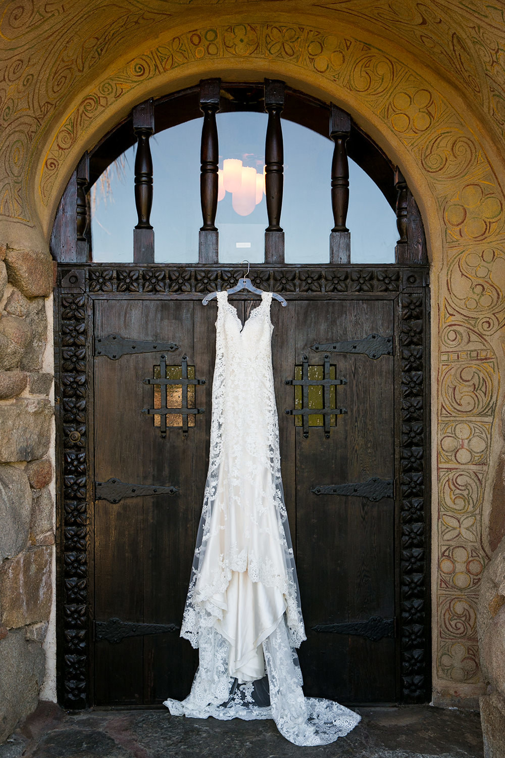 bridal dress hanging on door