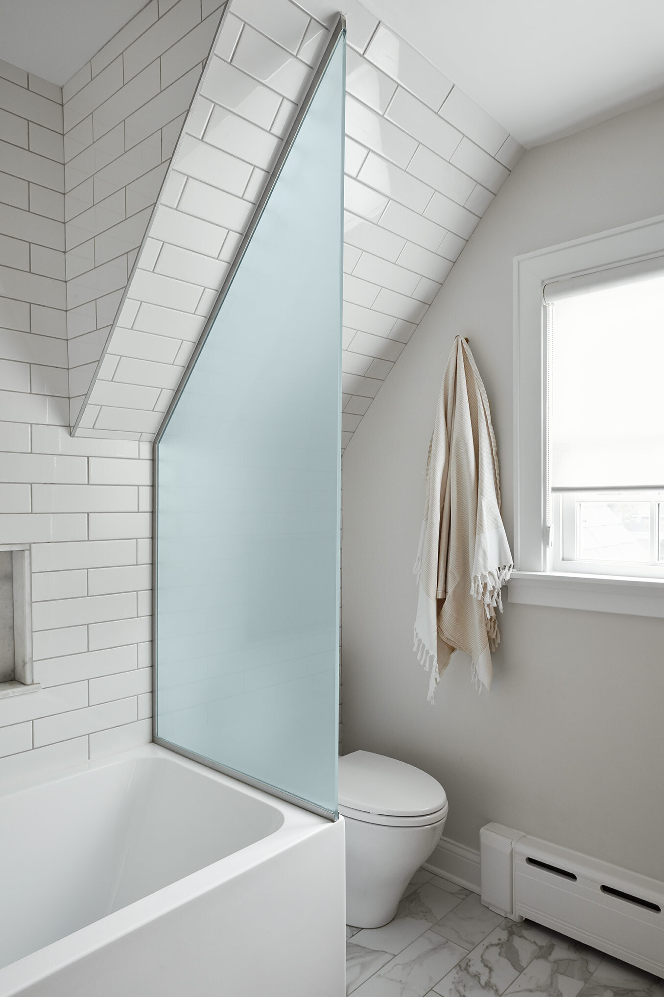Shower with white tiles and grey walls