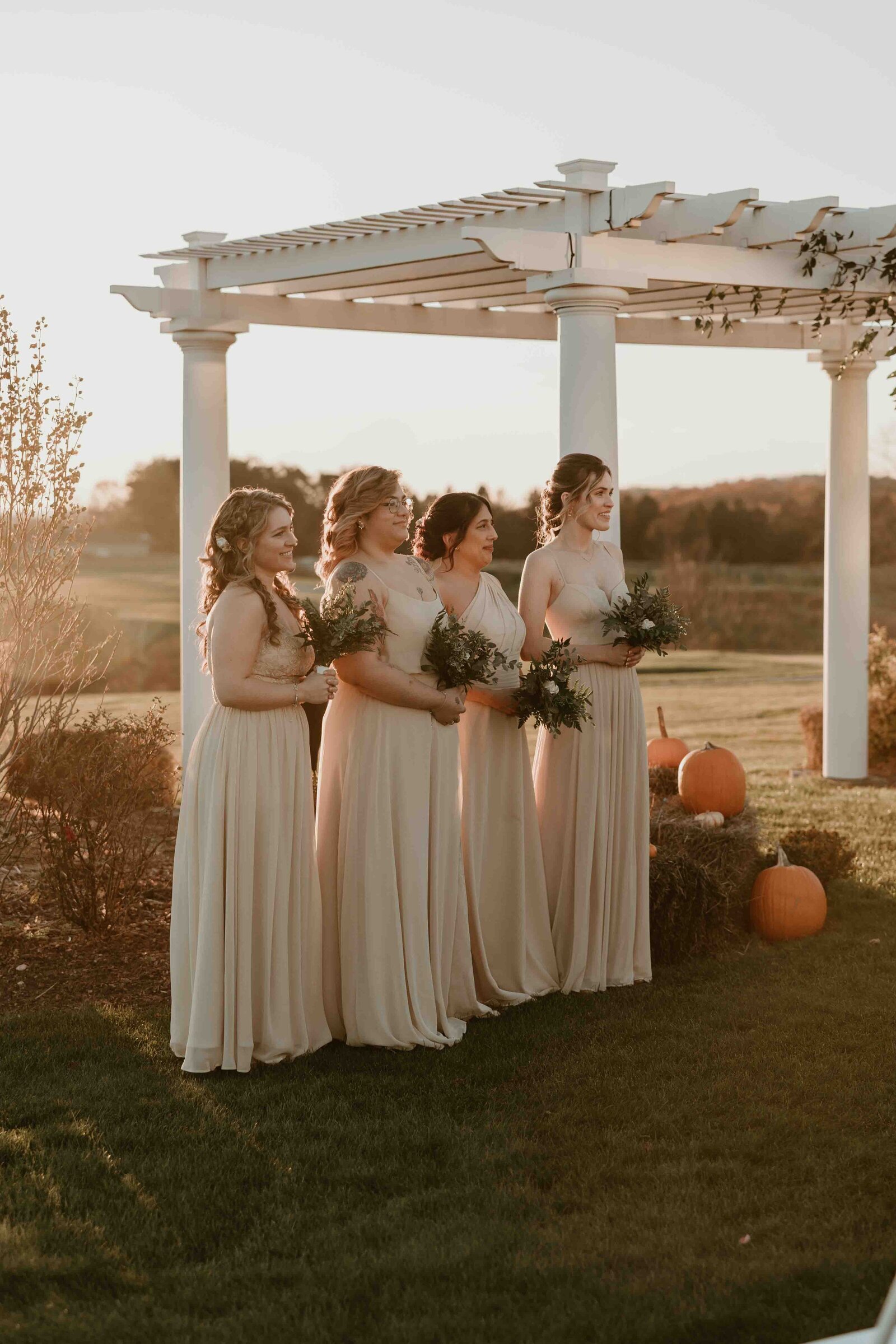 Bridemaids standing with bouquets.
