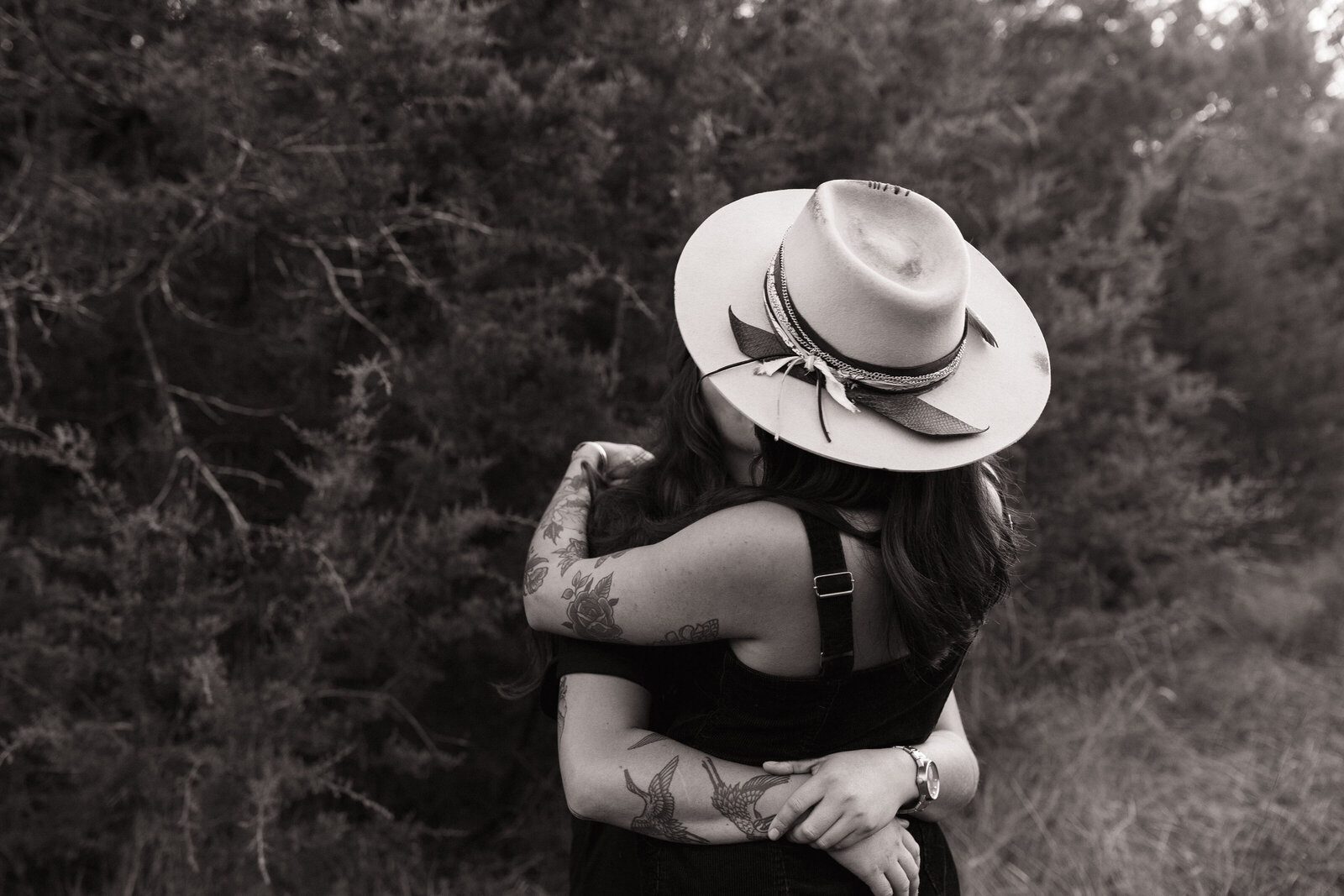 Close-up of two women sharing a kiss during golden hour Austin session