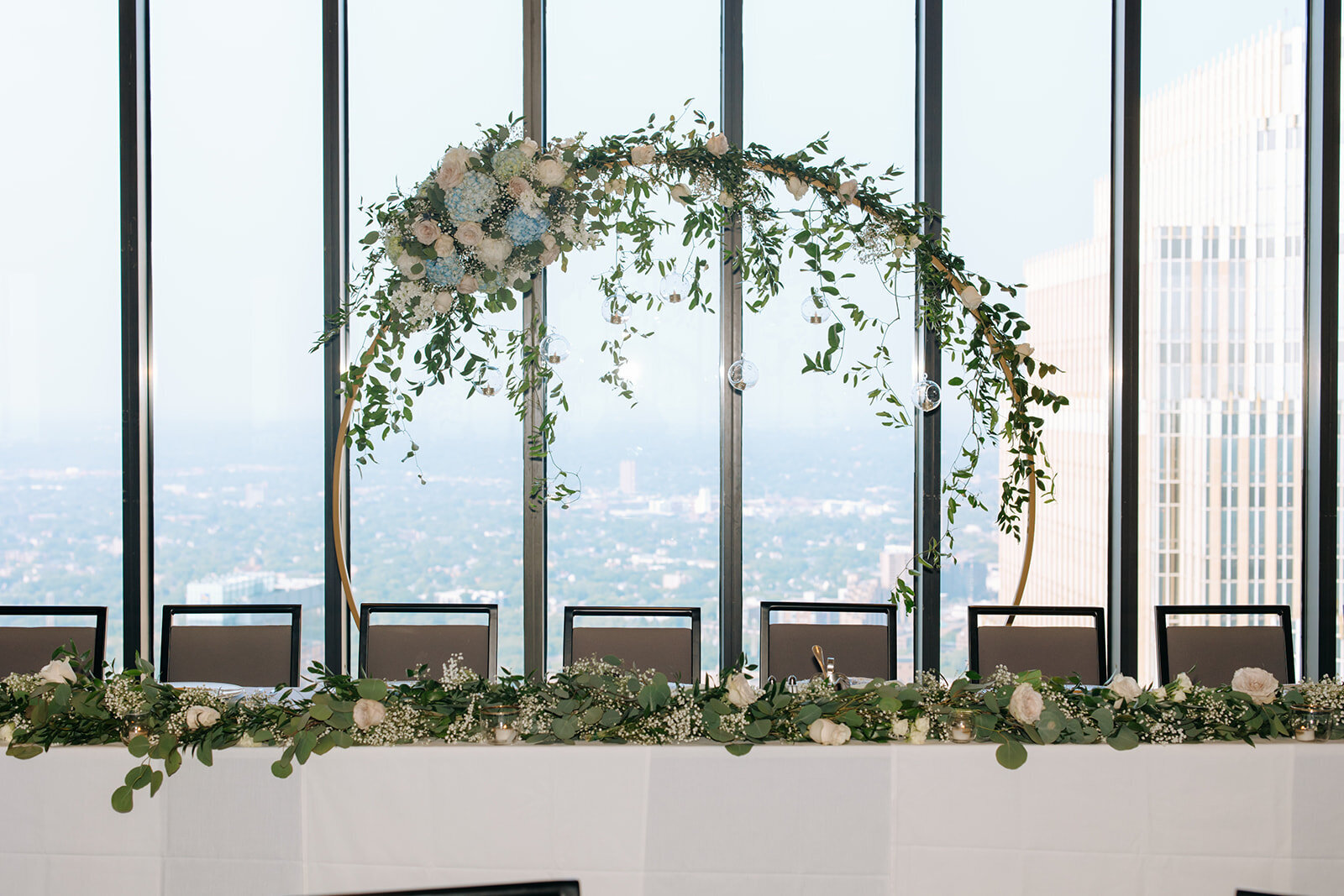wedding-arch-behind-head-table-windows-on-marquette