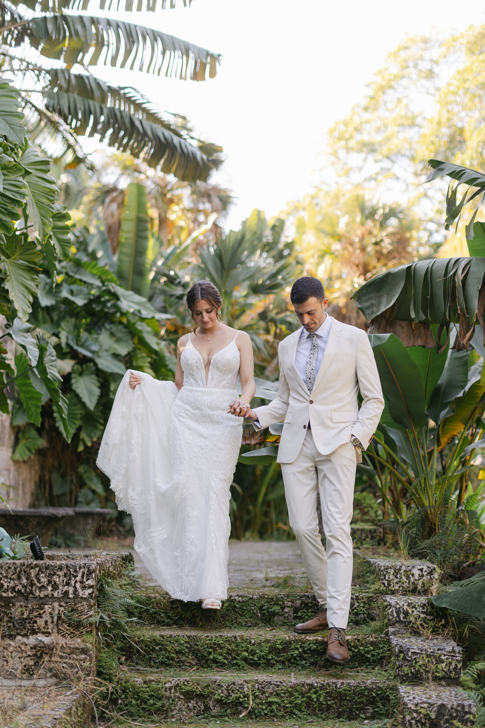 Bride and Groom holding hands as they walk around the Fairchild Botanical Garden in Coral Gables, Florida. Photo by Maggie Alvarez 