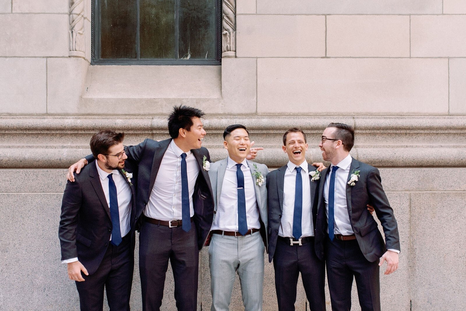 Candid moment Groom with his groomsmen toronto financial district downtown toronto wedding jacqueline james photography