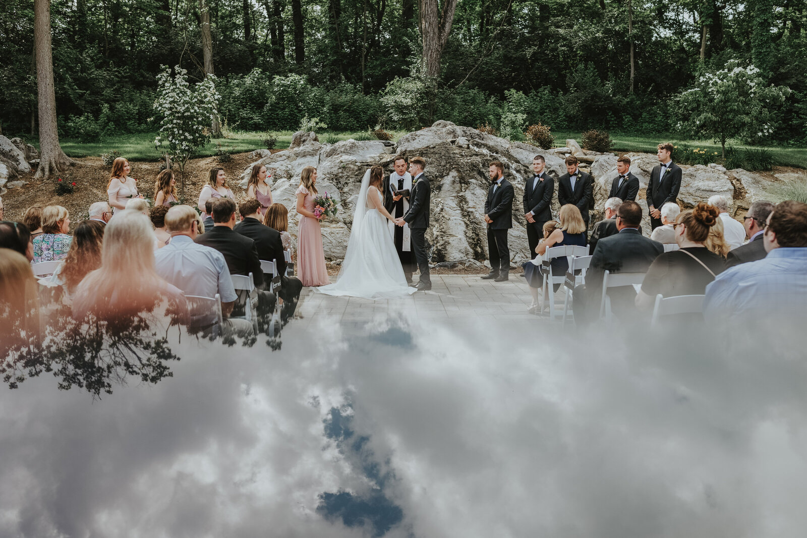 The sky reflects on the ground during a wedding ceremony