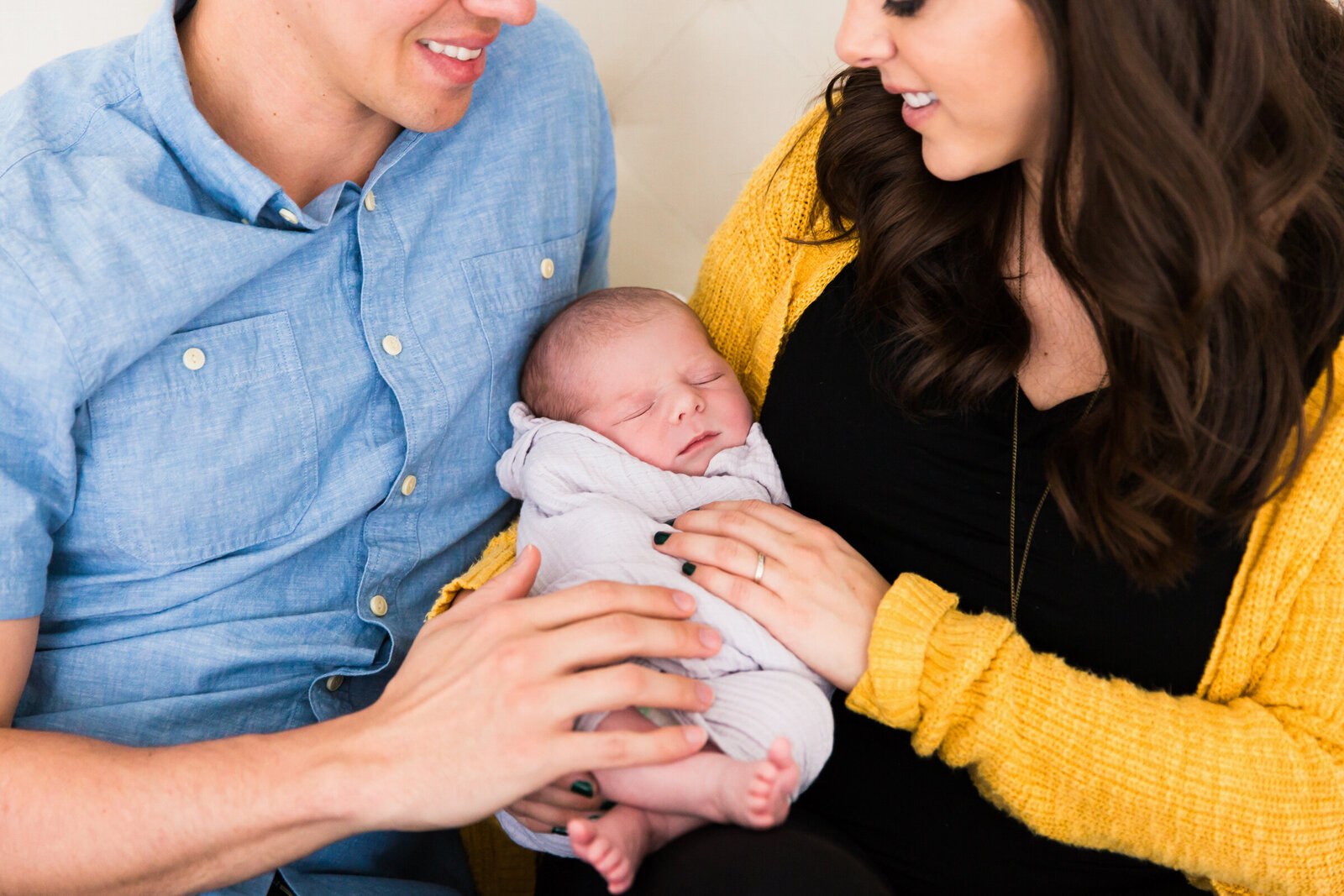 mom and dad holding newborn baby boy