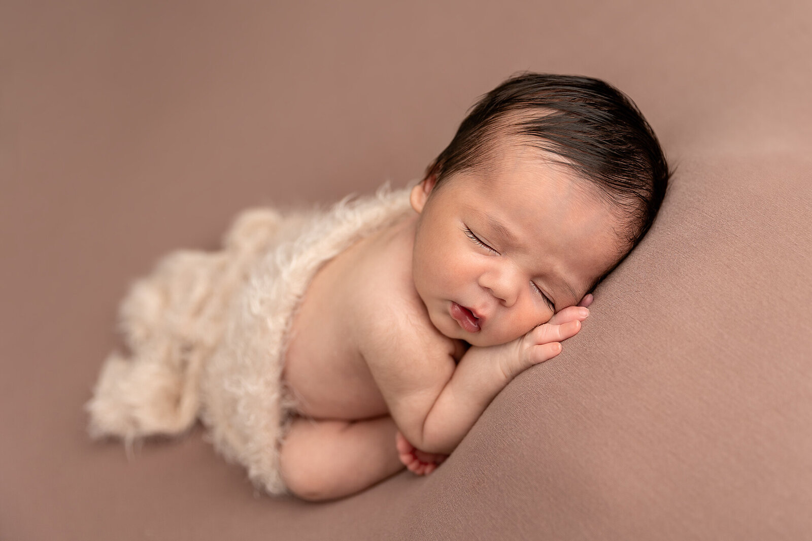 baby sleeping on brown background by Newborn Photography Bucks County PA