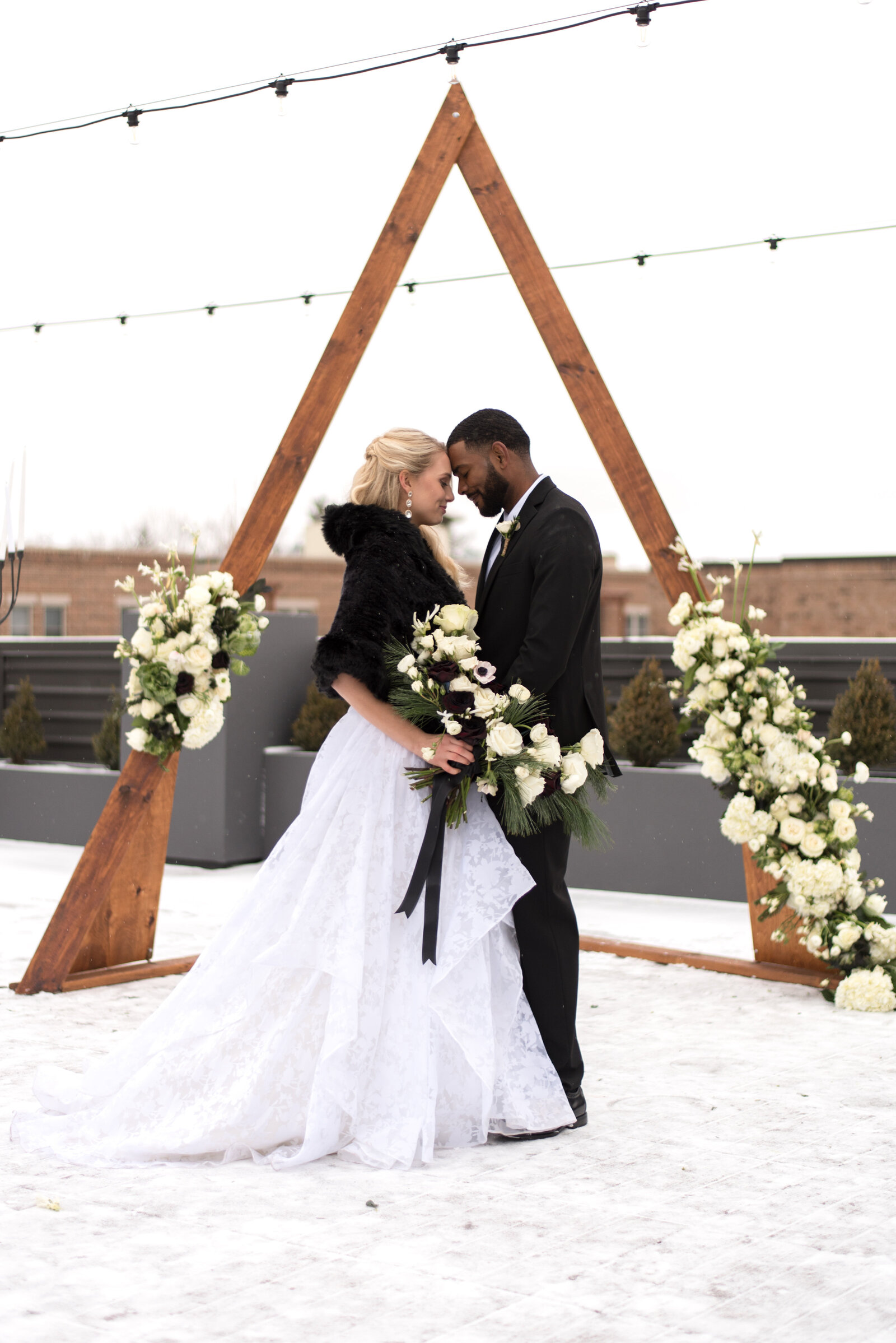 Bride and groom on rooftop in winter