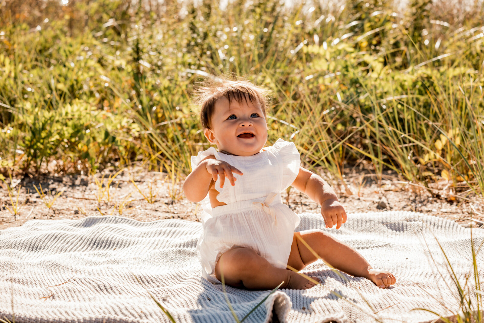 little girl sitting at the beach