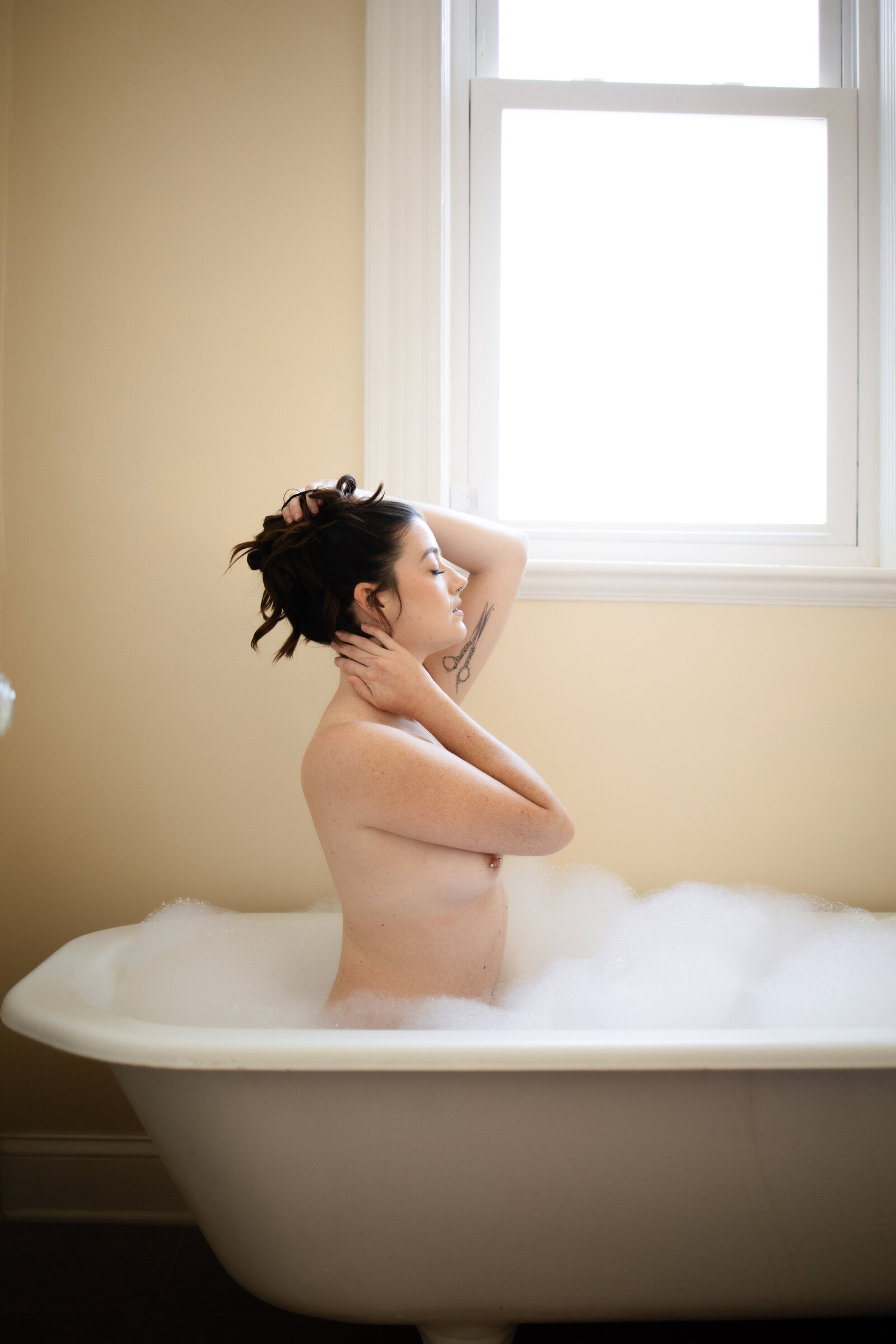 Nude woman in bathtub