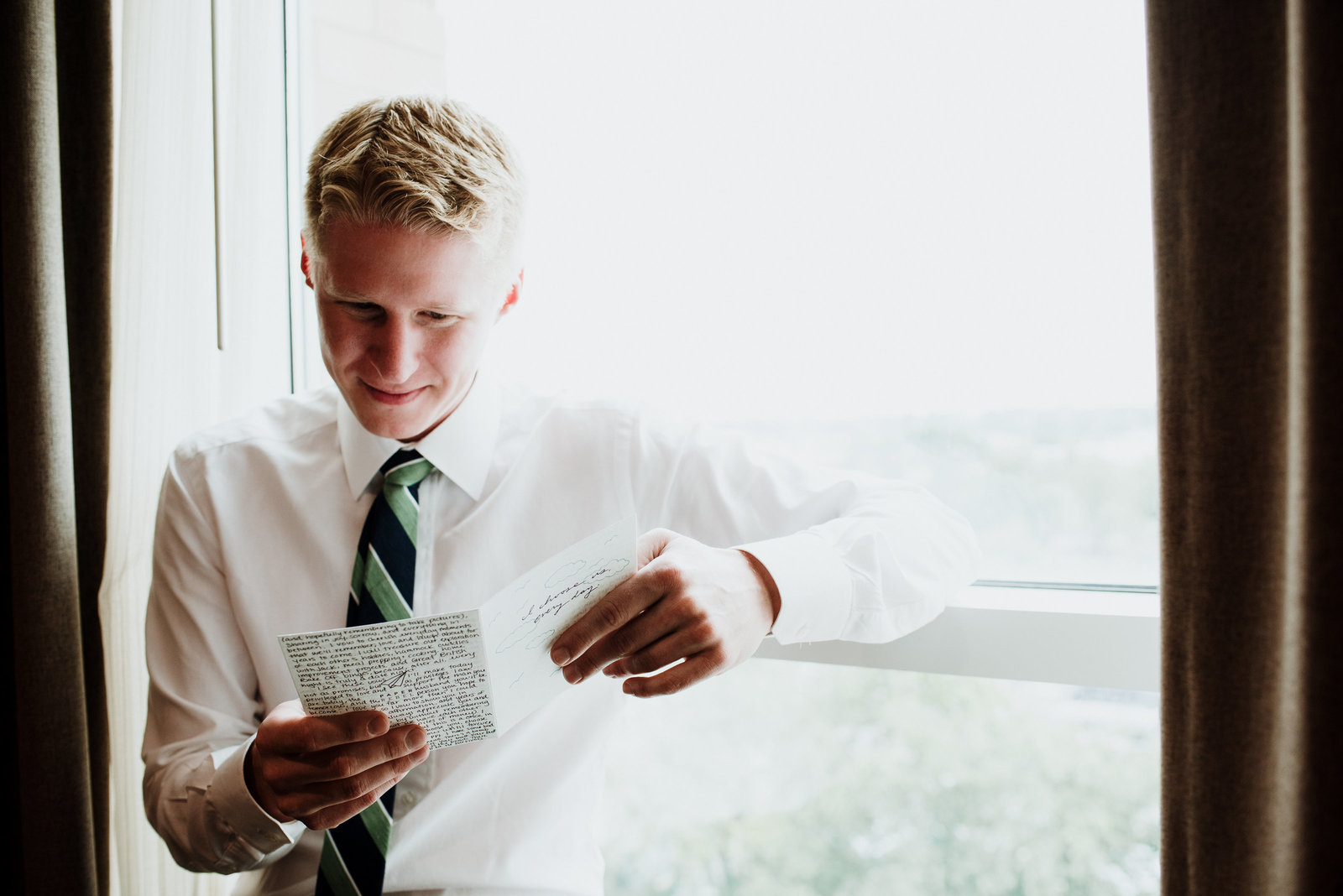 groom reading notes from bride during wedding day