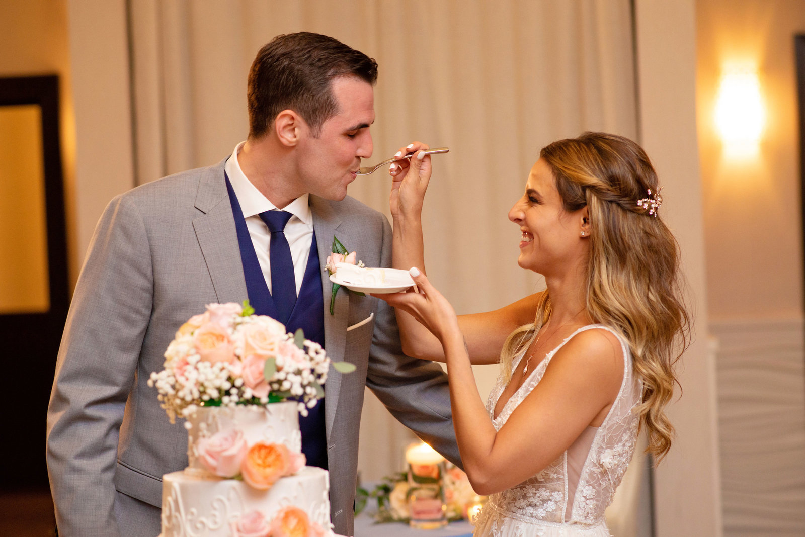 Bride feeding groom cake at Atlantis Banquet and Events
