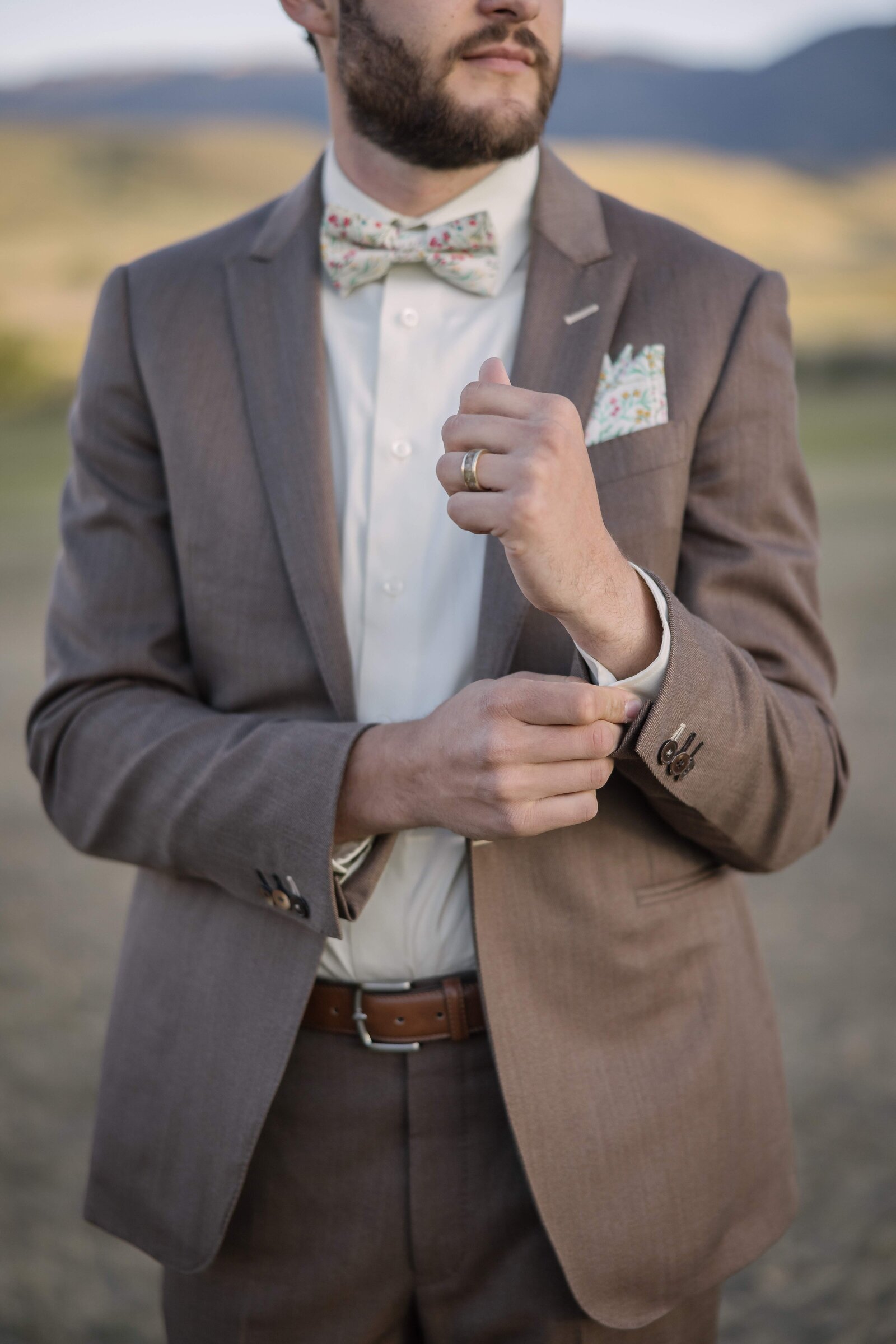 groom adjusting cuff links