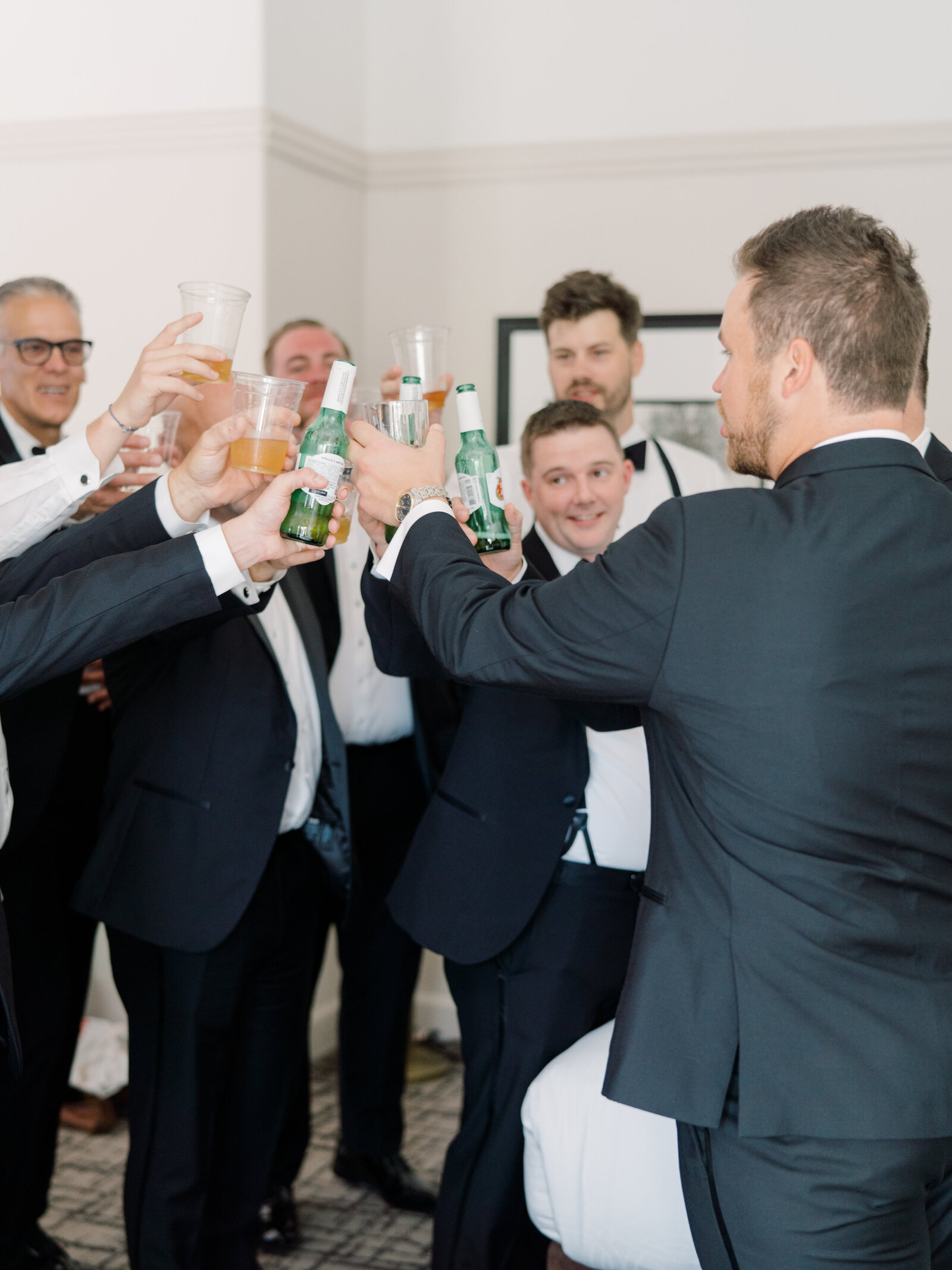 groom and groomsmen making a toast