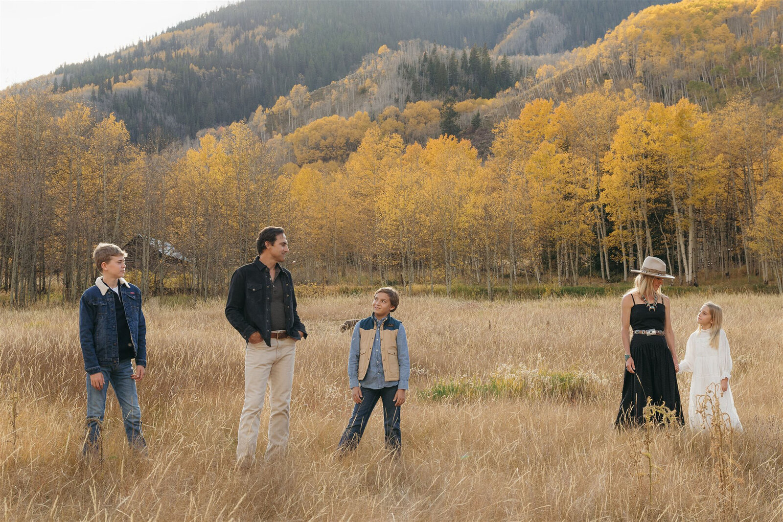 Luxury Aspen family photography — the Stanley family styled in Ralph Lauren–inspired layers with the Rocky Mountains in the background.