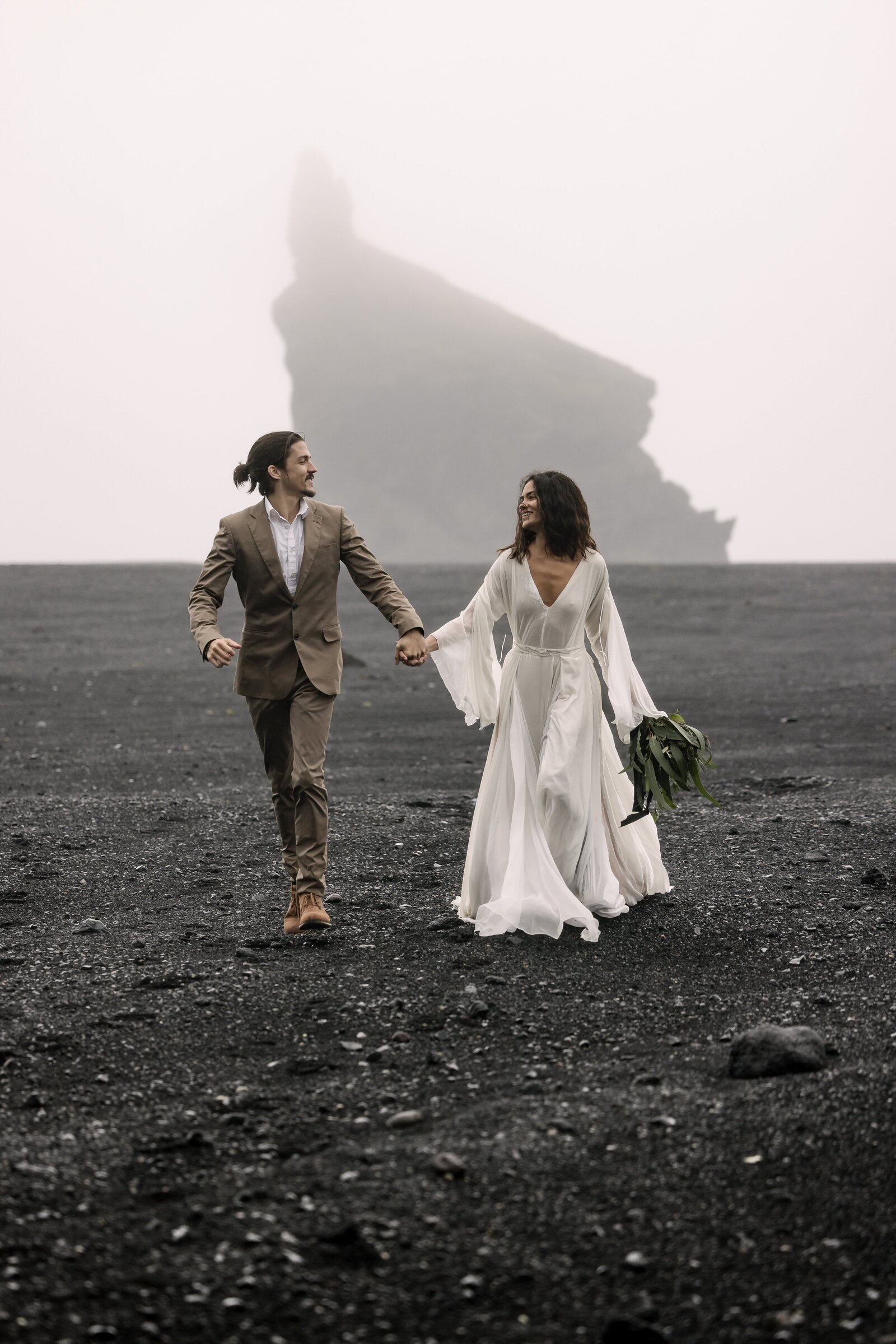 bride and groom running towards camera