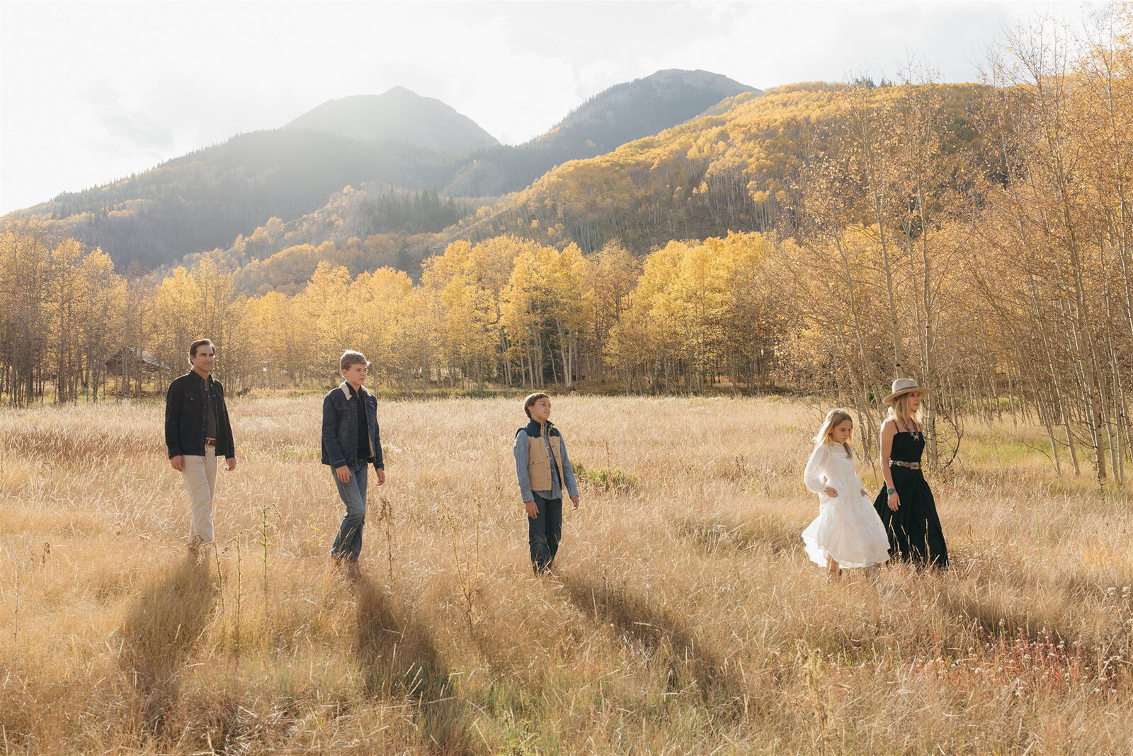Aspen family photography with a Ralph Lauren aesthetic — navy, camel, and cream tones against alpine greens in the Roaring Fork Valley.