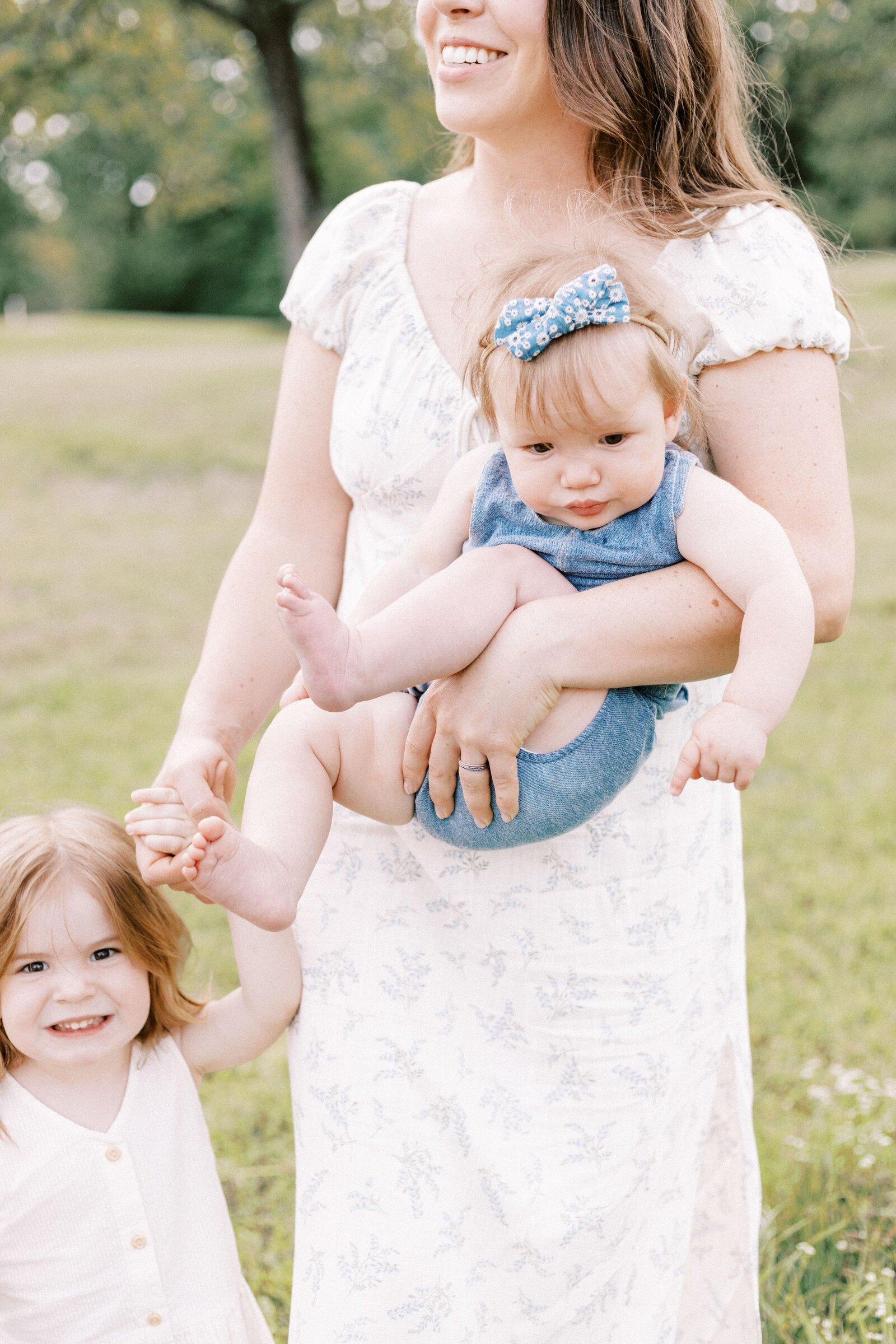 mom holding baby during peoria illinois family photos 