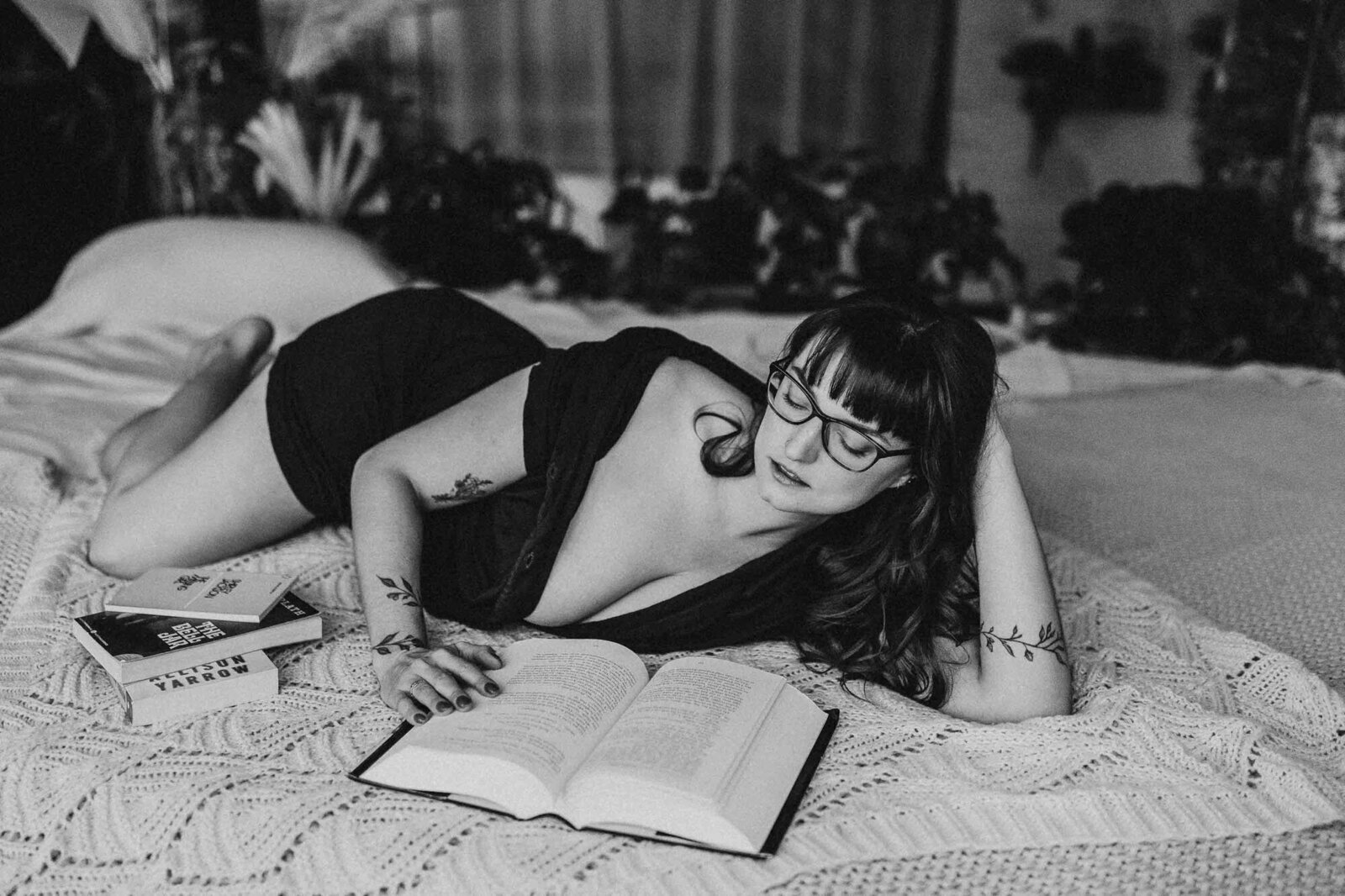 black and white photo of woman reading a book