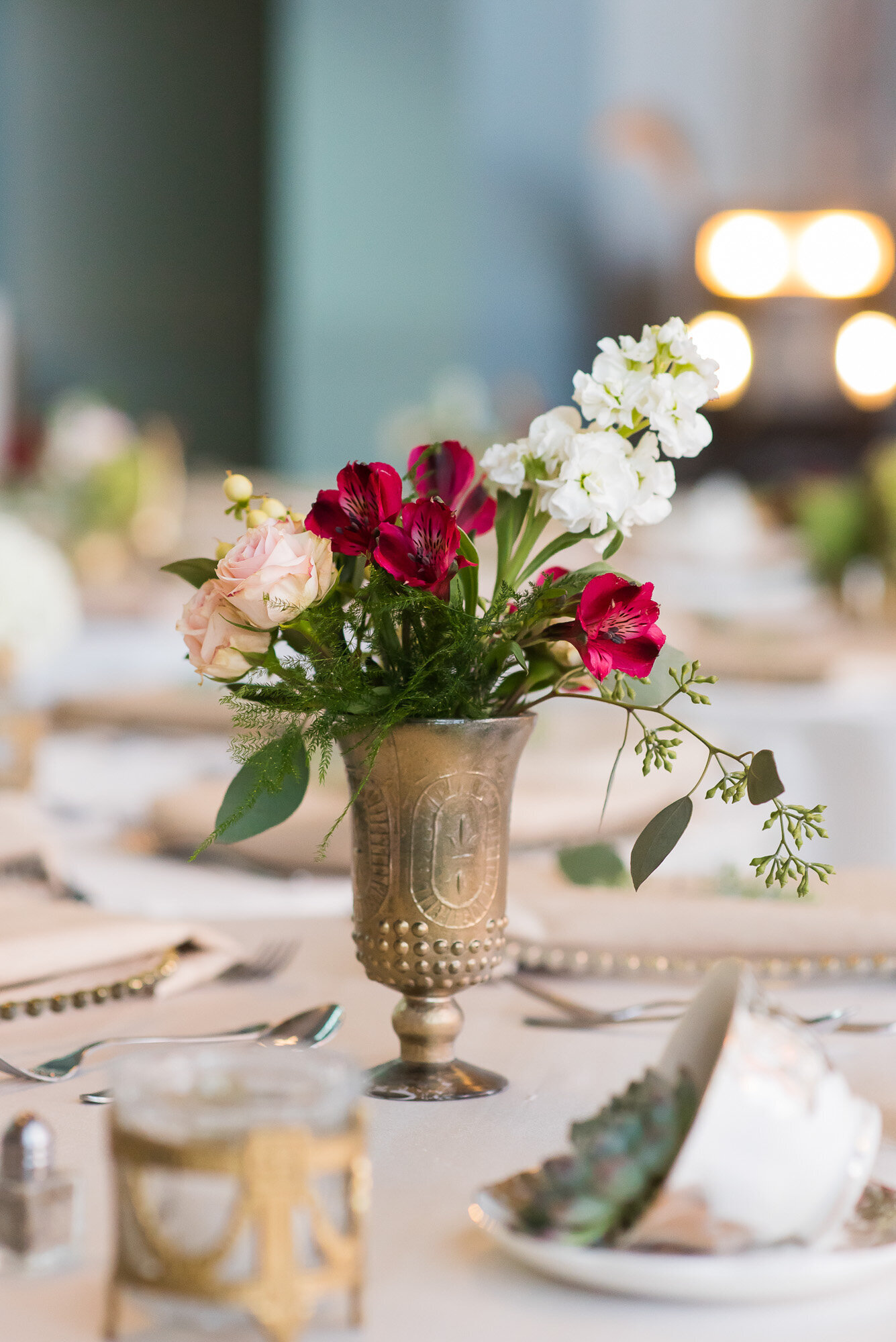 Floral centerpiece in a golden vintage vase