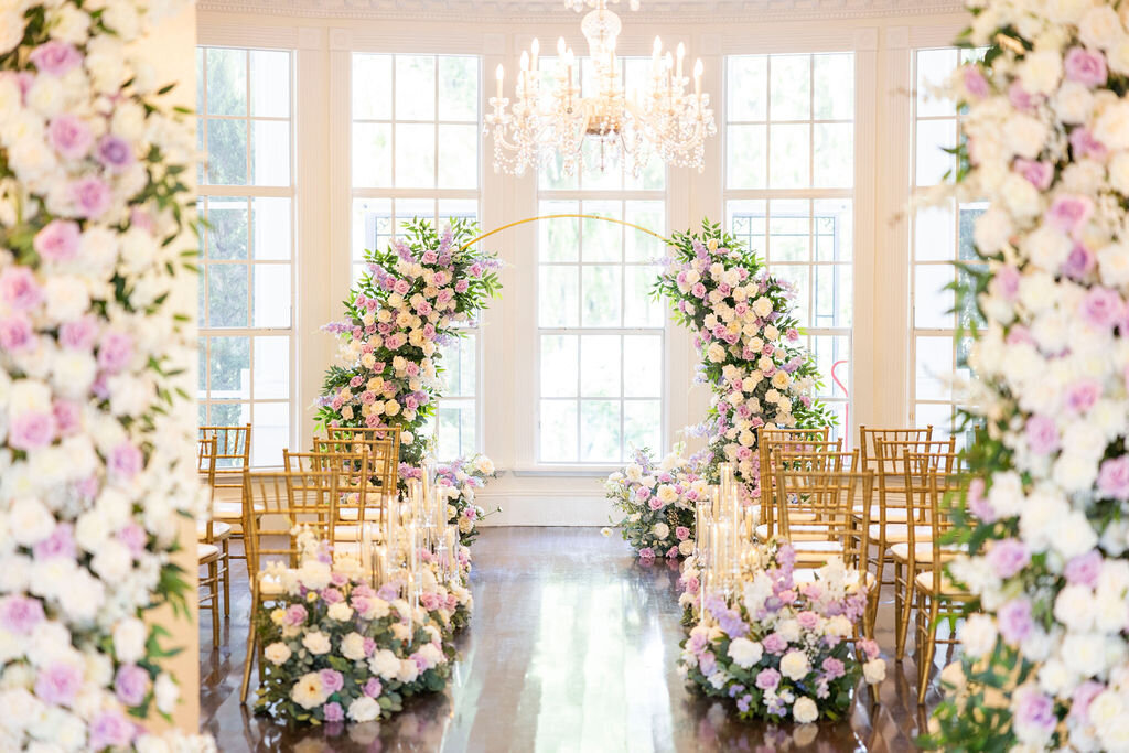 A luxurious indoor wedding at a Central Florida estate, featuring stunning silk floral arrangements and breathtaking arch centerpiece. Perfect for couples seeking elegance and timeless beauty in a private, exclusive setting.