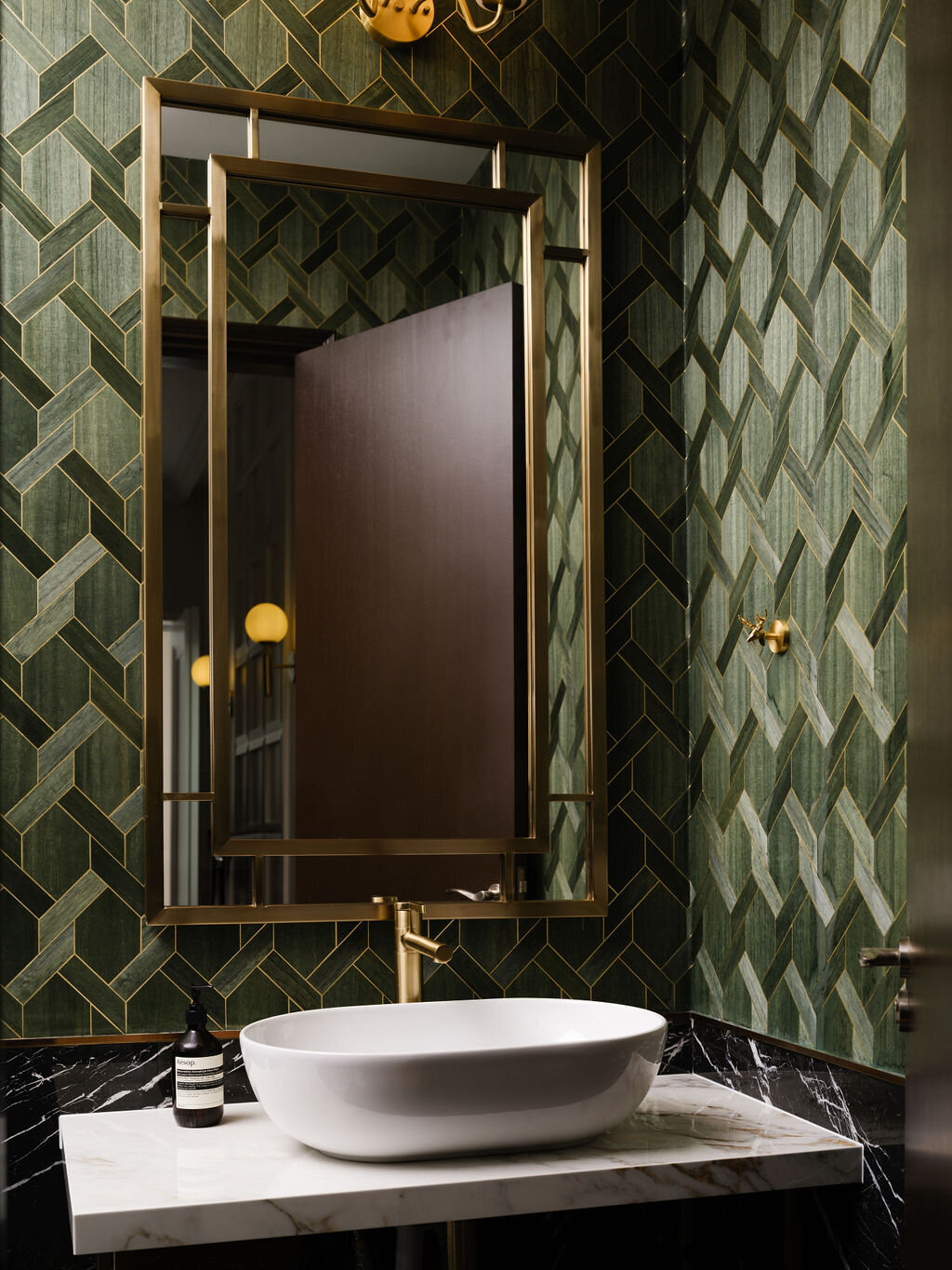 green wallpaper and bathroom sink