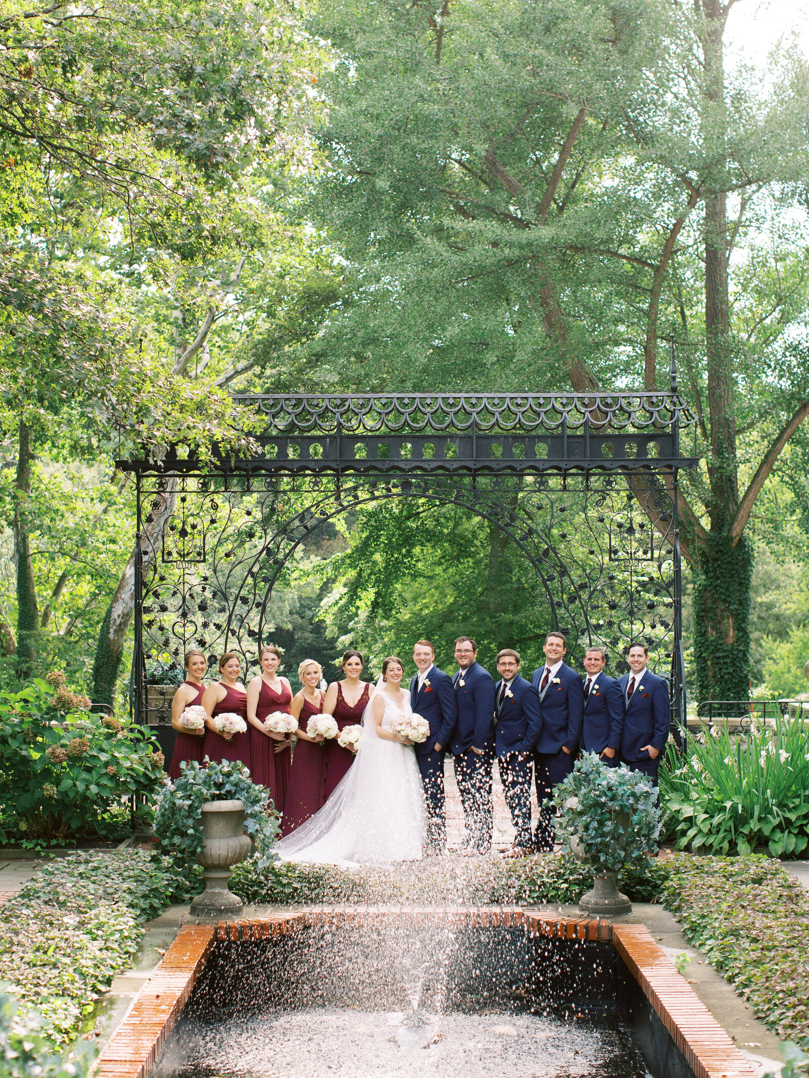 bridal party portrait under iron gate at the hungarian  cleveland cultural garden