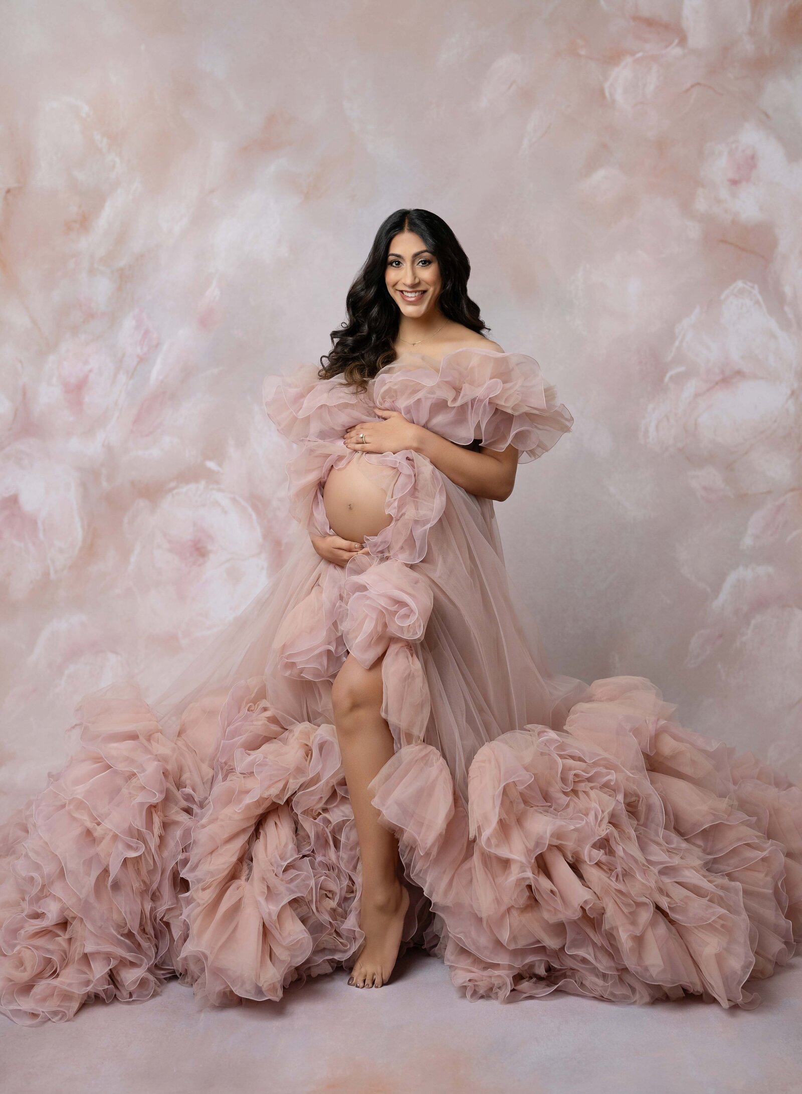 Pregnant women in pink maternity gown with belly showing. Photo taken by Jenni Nikki at Luxury maternity photo studio in Woodstock, GA.