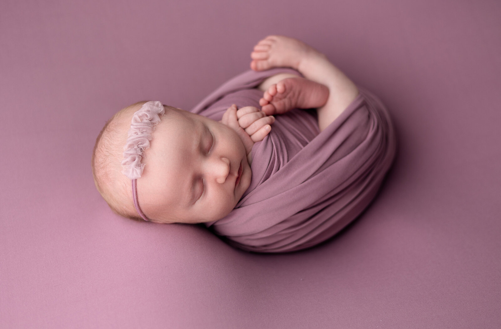 Baby girl wrapped in pink in studio Erie, PA