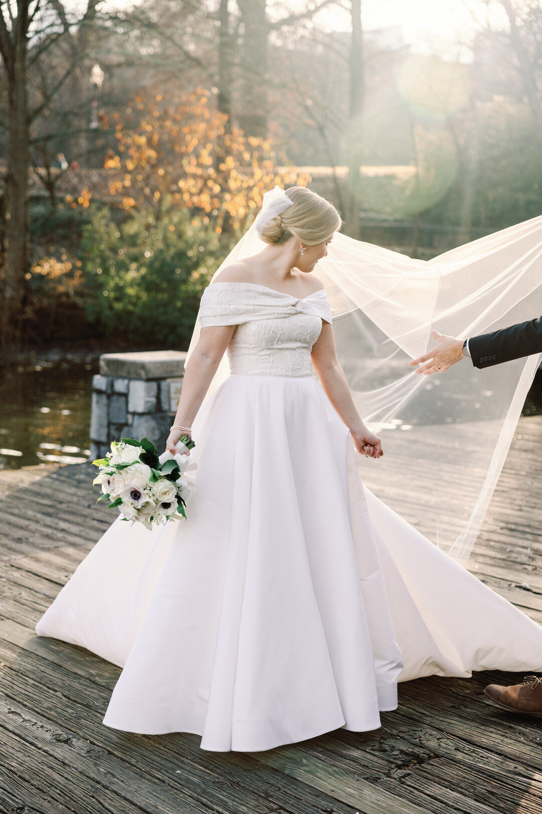 Bride on Dock fixing veil at Piedmont park