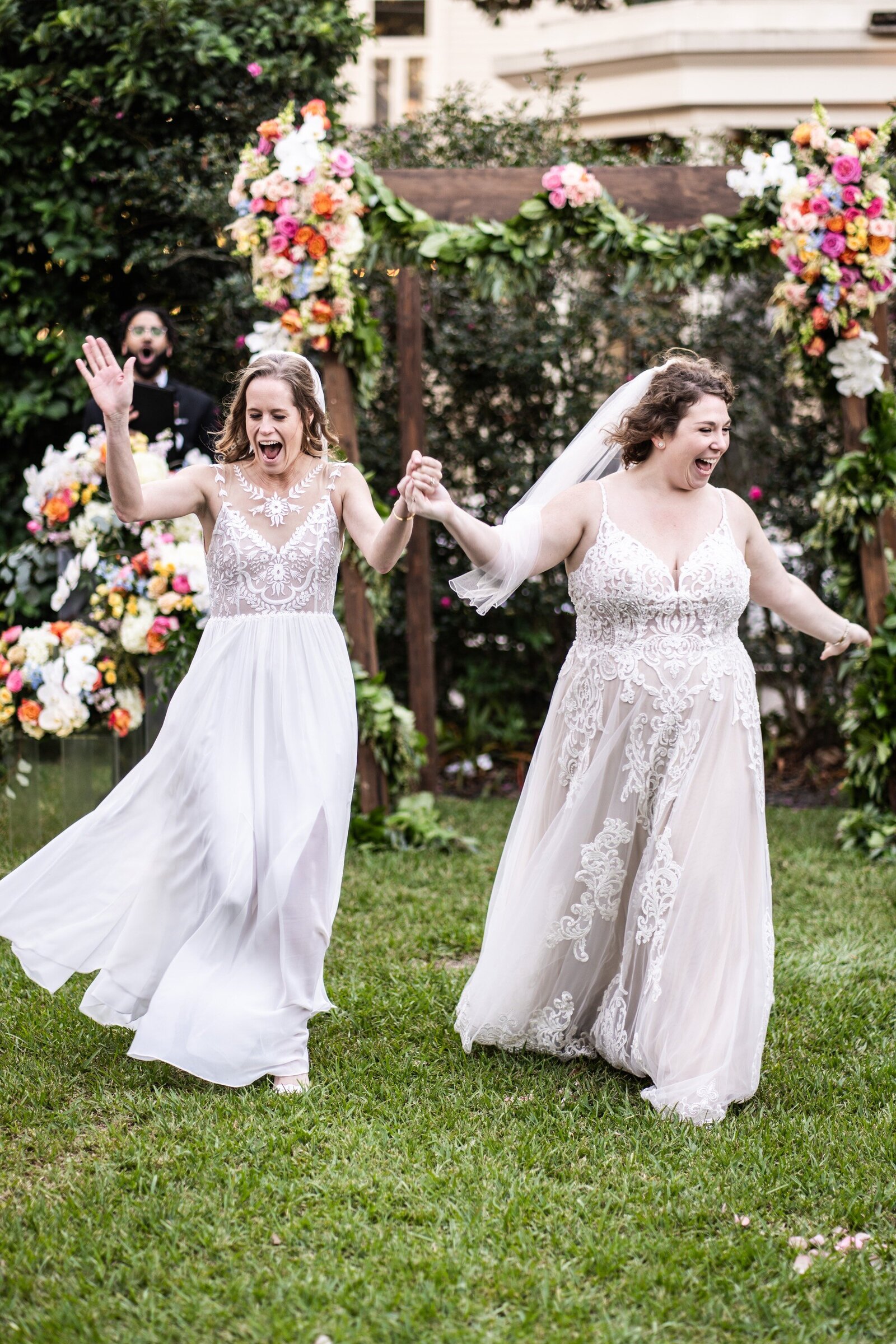 Two brides walk down the aisle at Elms Mansion wedding
