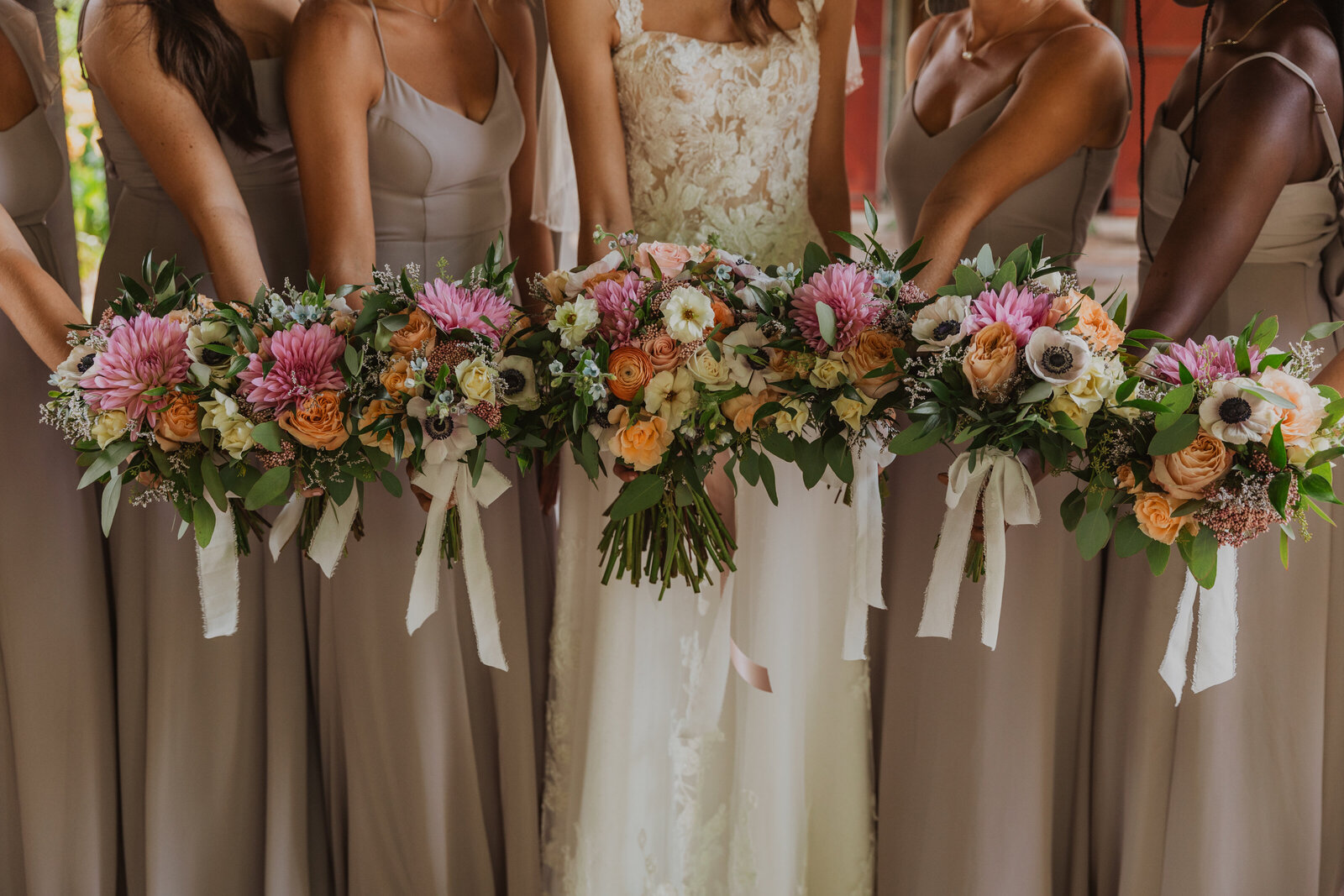 Lush bridesmaid bouquets with wildflowers and greenery for a touch of bohemian beauty.