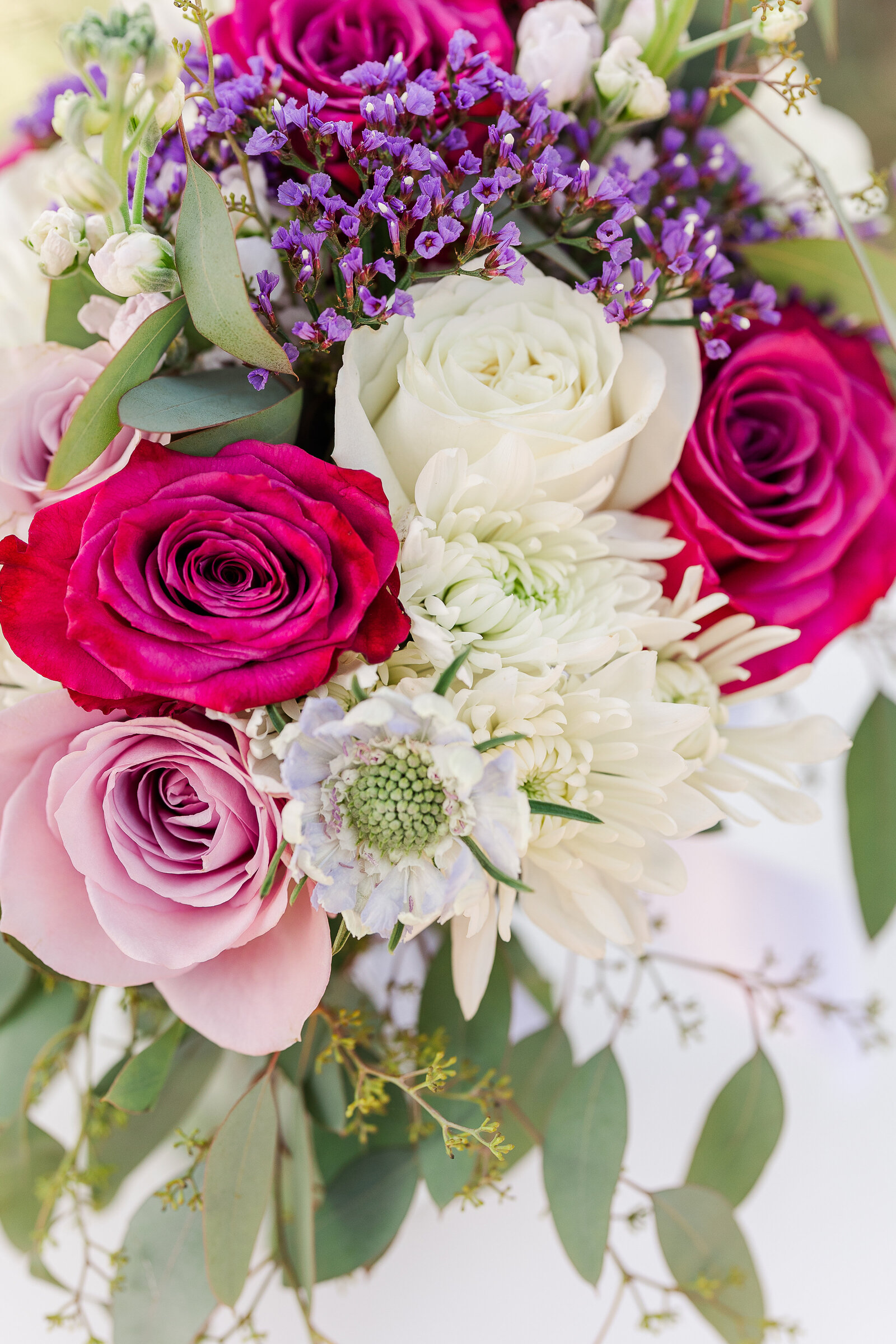 Bridal bouquet with purple, white, pink, and lush greenery at a Ridgway State Park wedding, creating a romantic and timeless look