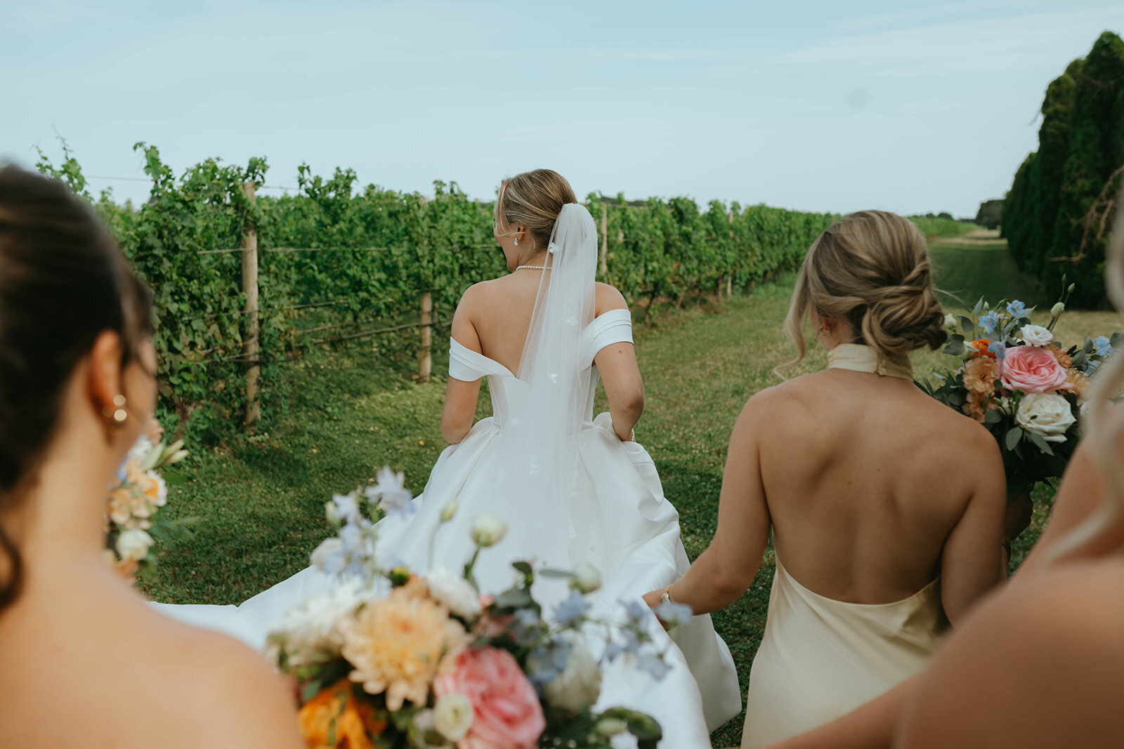 bride walking with bridesmaids by elsie goodman photography, wedding photography prices