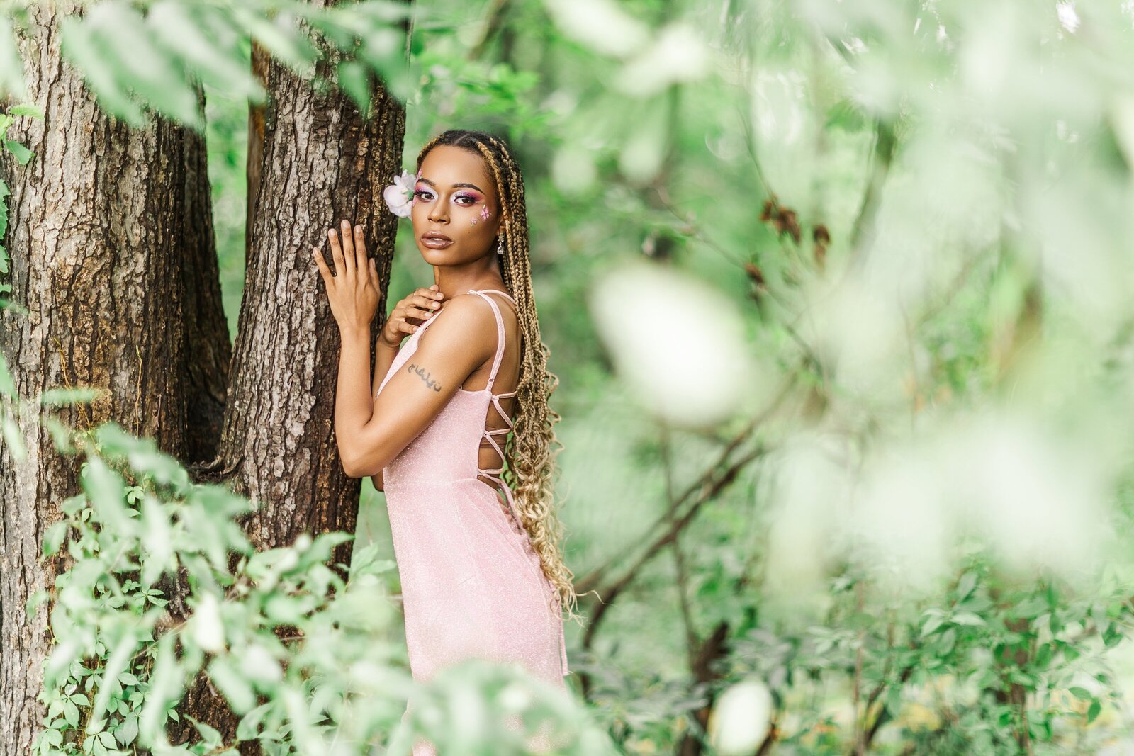 woman in pink dress posing with tree and greenery in albany ny