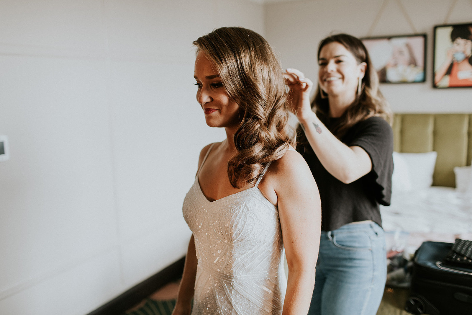 Brielle Brenner fixing her bridal client's hair in hotel room