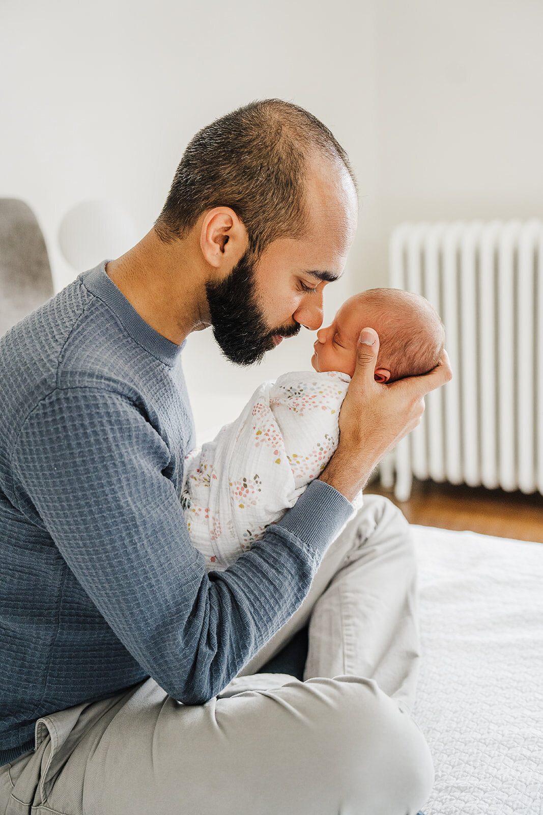 father and son are nose to nose during newborn session