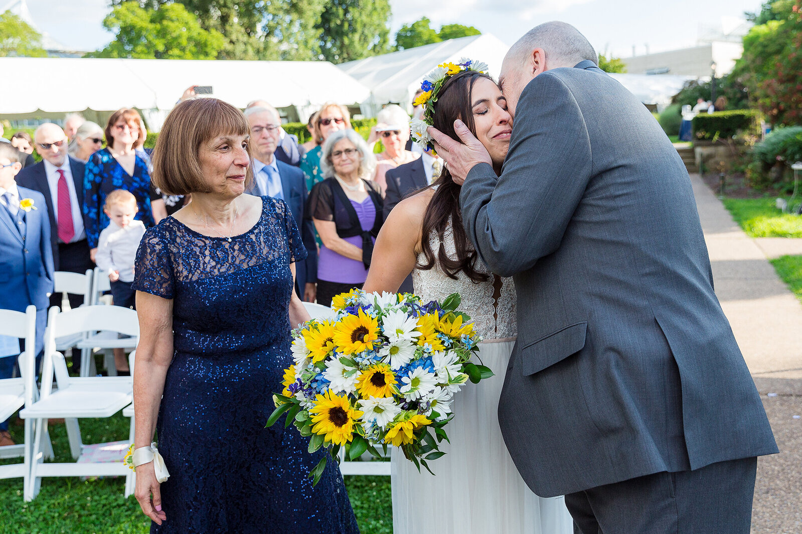 Dad kissing bride before giving her away to groom during outdoor Dallas wedding ceremony