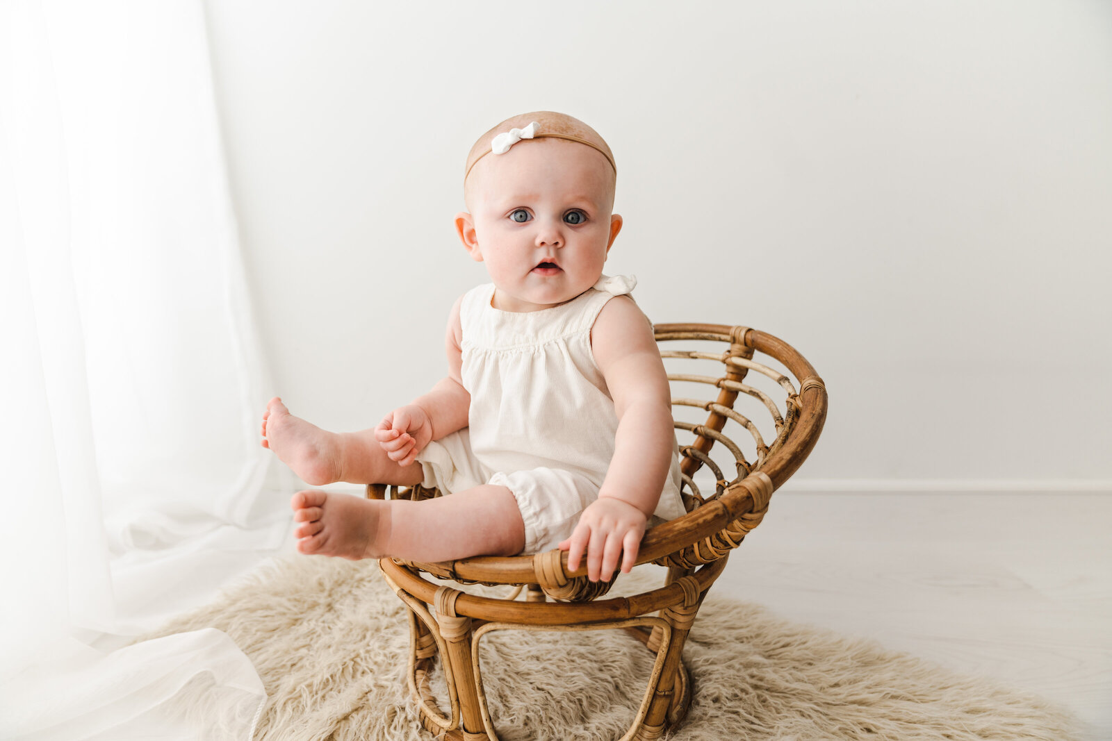 baby sitting in wooden chair
