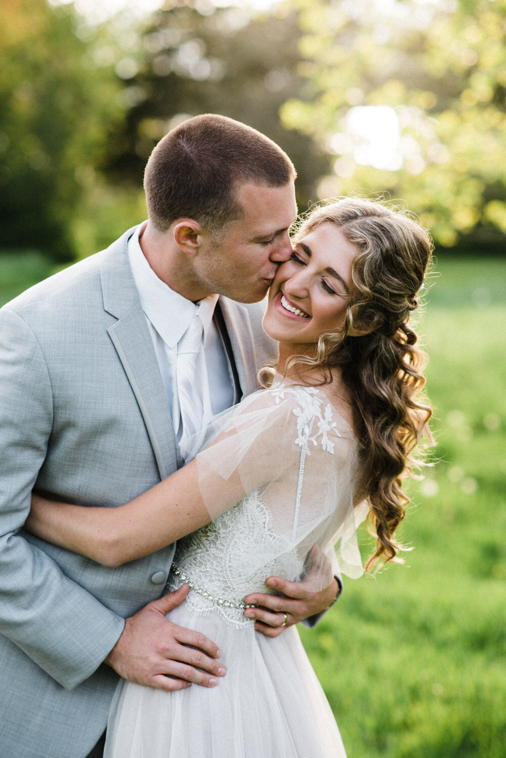 groom kiss bride on cheek