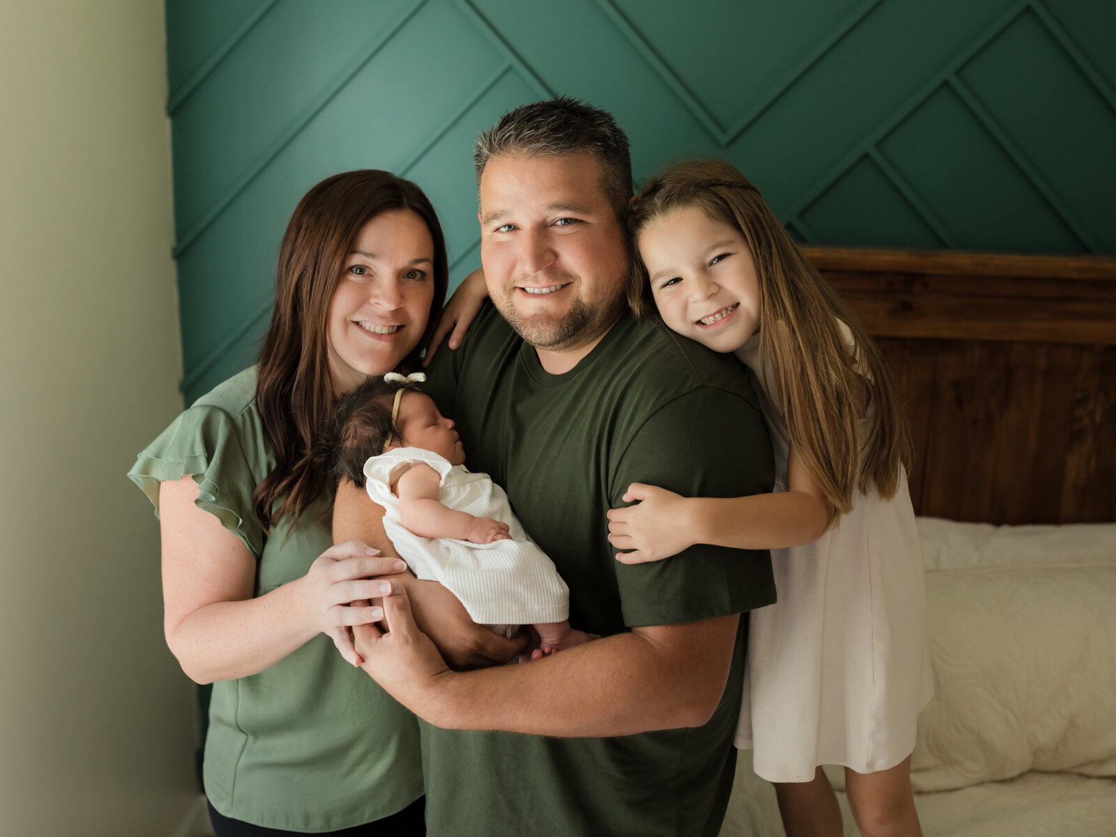 family holding newborn baby girl for in home lifestyle session cleveland newborn photographer