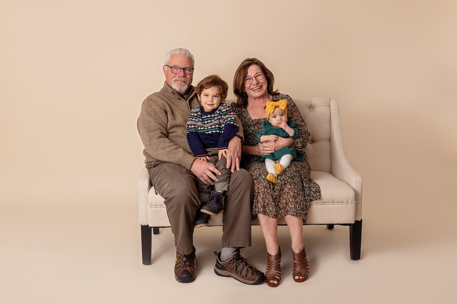 grandparents with grandkids on studio couch by Philadelphia Family Photographer