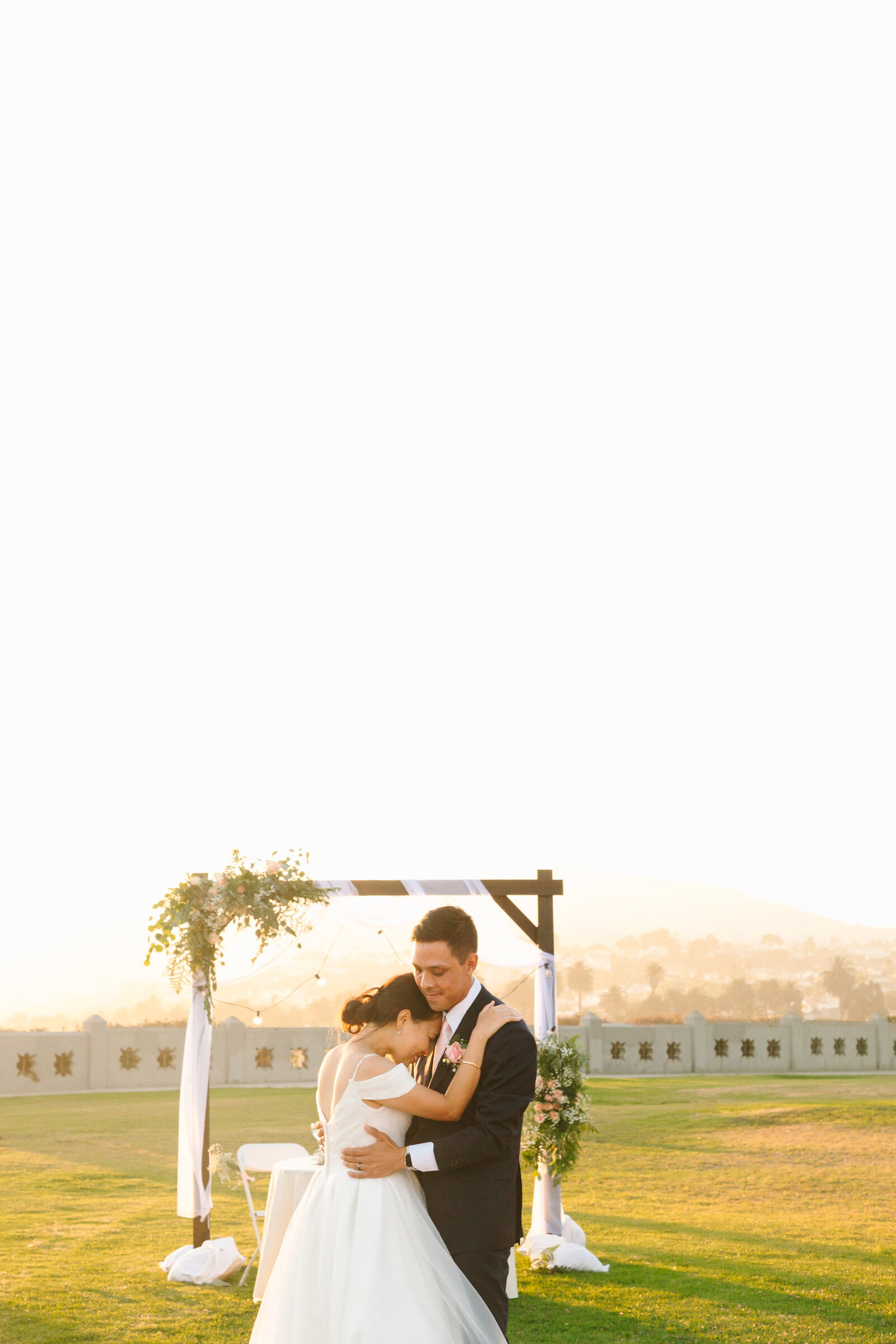 Newlyweds share their fist dance at their beach wedding in Los Angeles.
