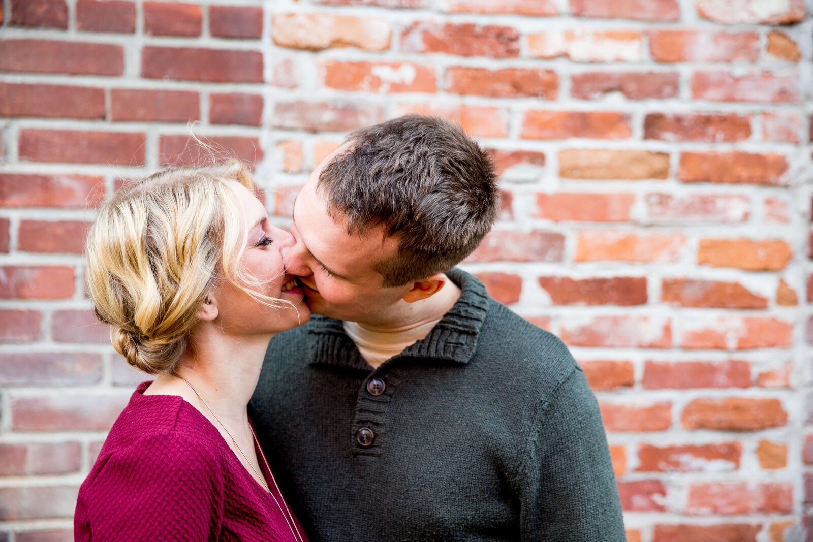 Couple kiss during engagement photo session.