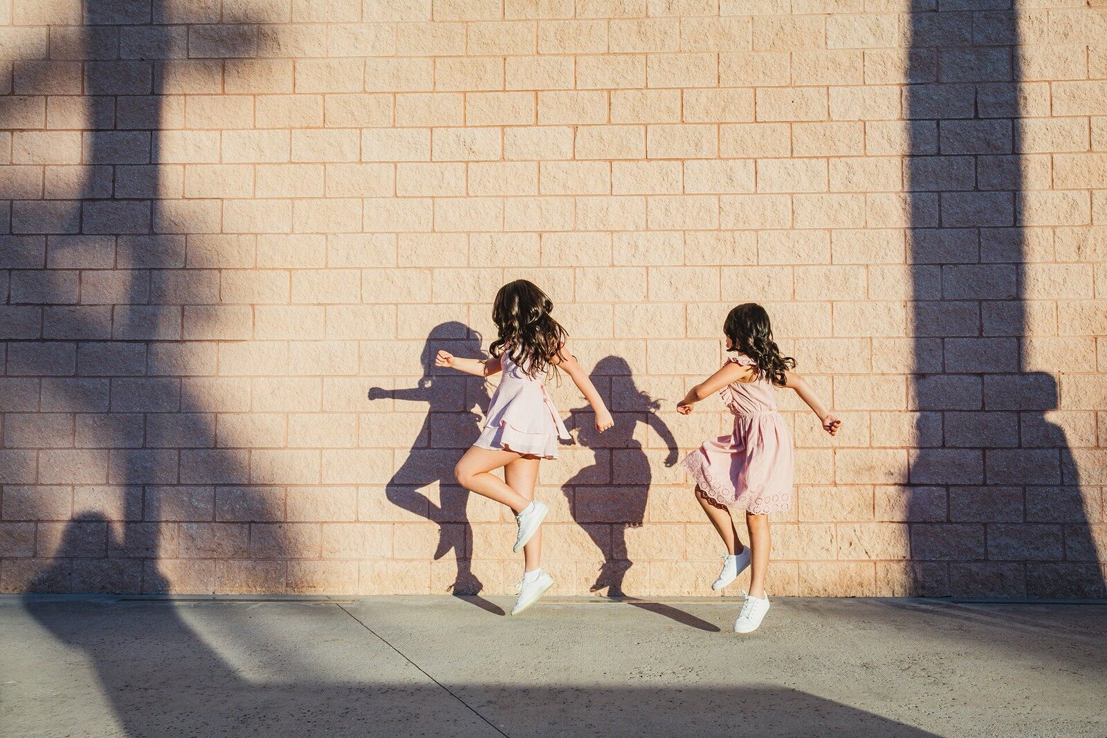 siblings-skipping-florida-sidewalk